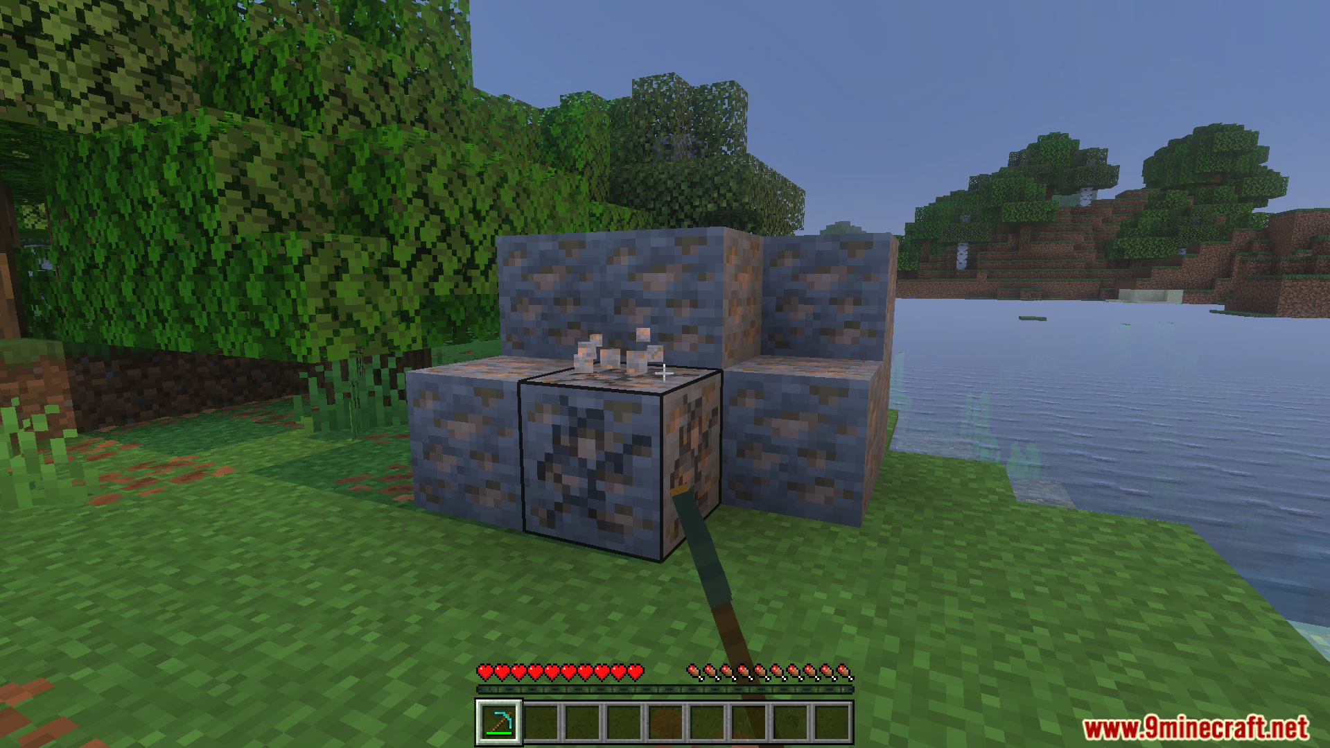 Player mining iron ore blocks with a pickaxe in survival mode