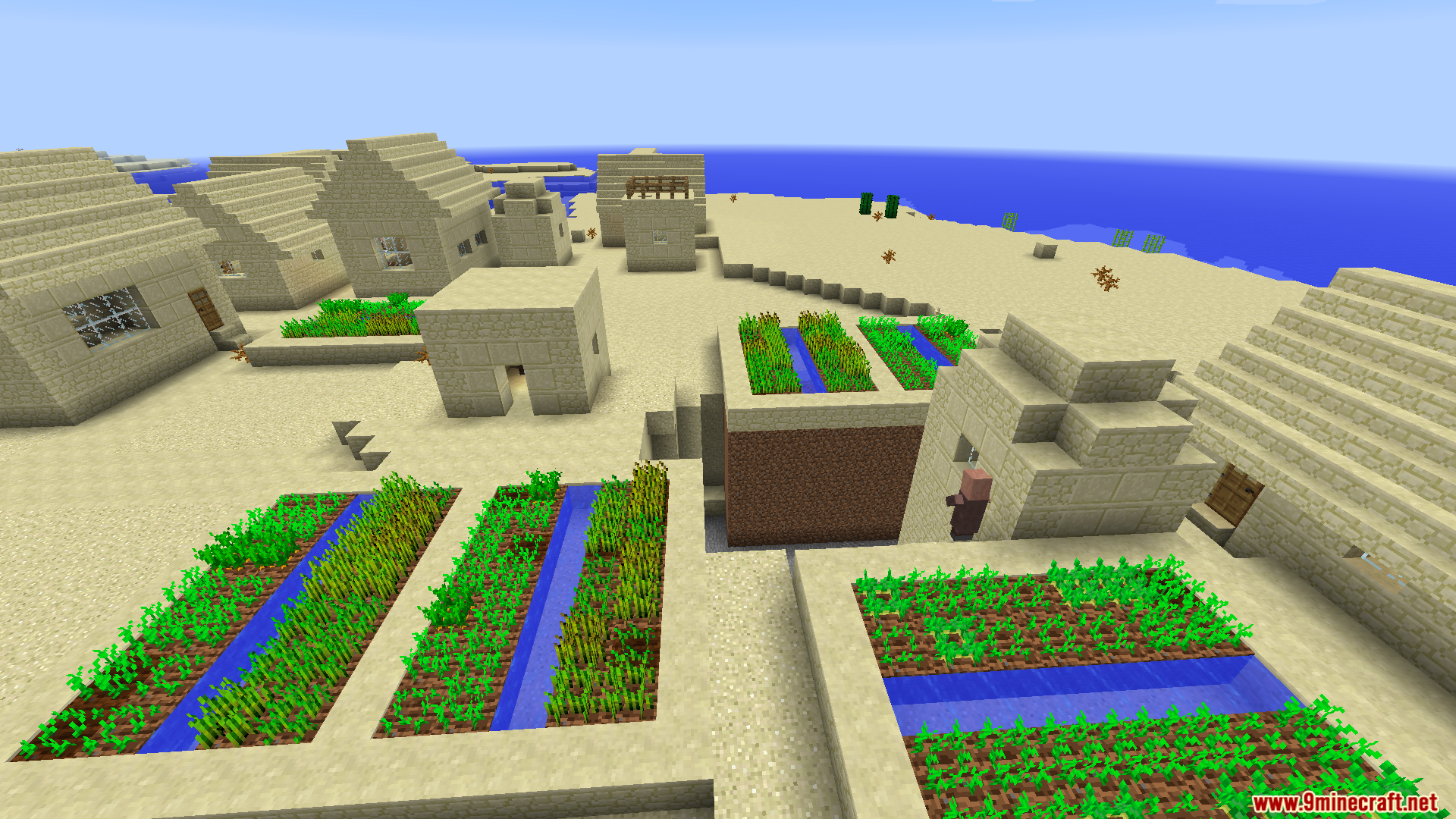 A villager walking through a desert village with farms