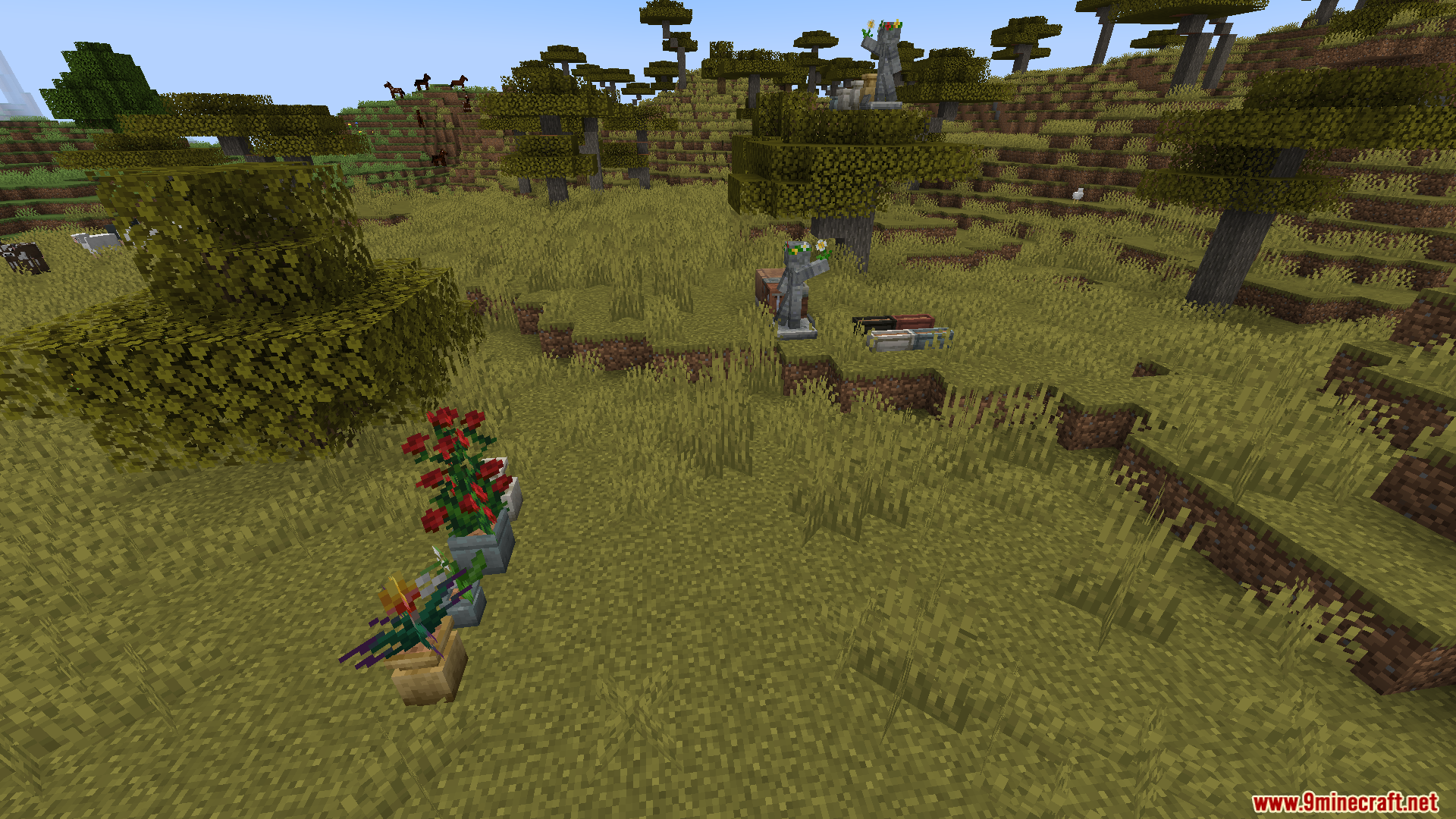 Lilis Pottery Mod Screenshot 13 Decorative ceramic planters holding flowers and small statues placed in a savanna biome