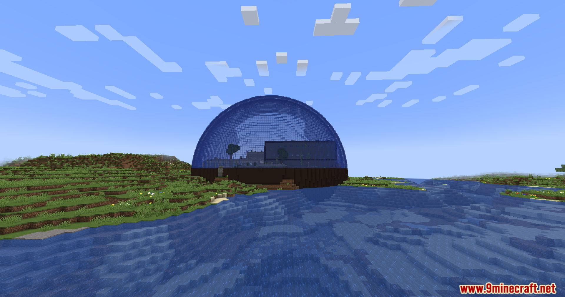 A large glass dome structure built by the water