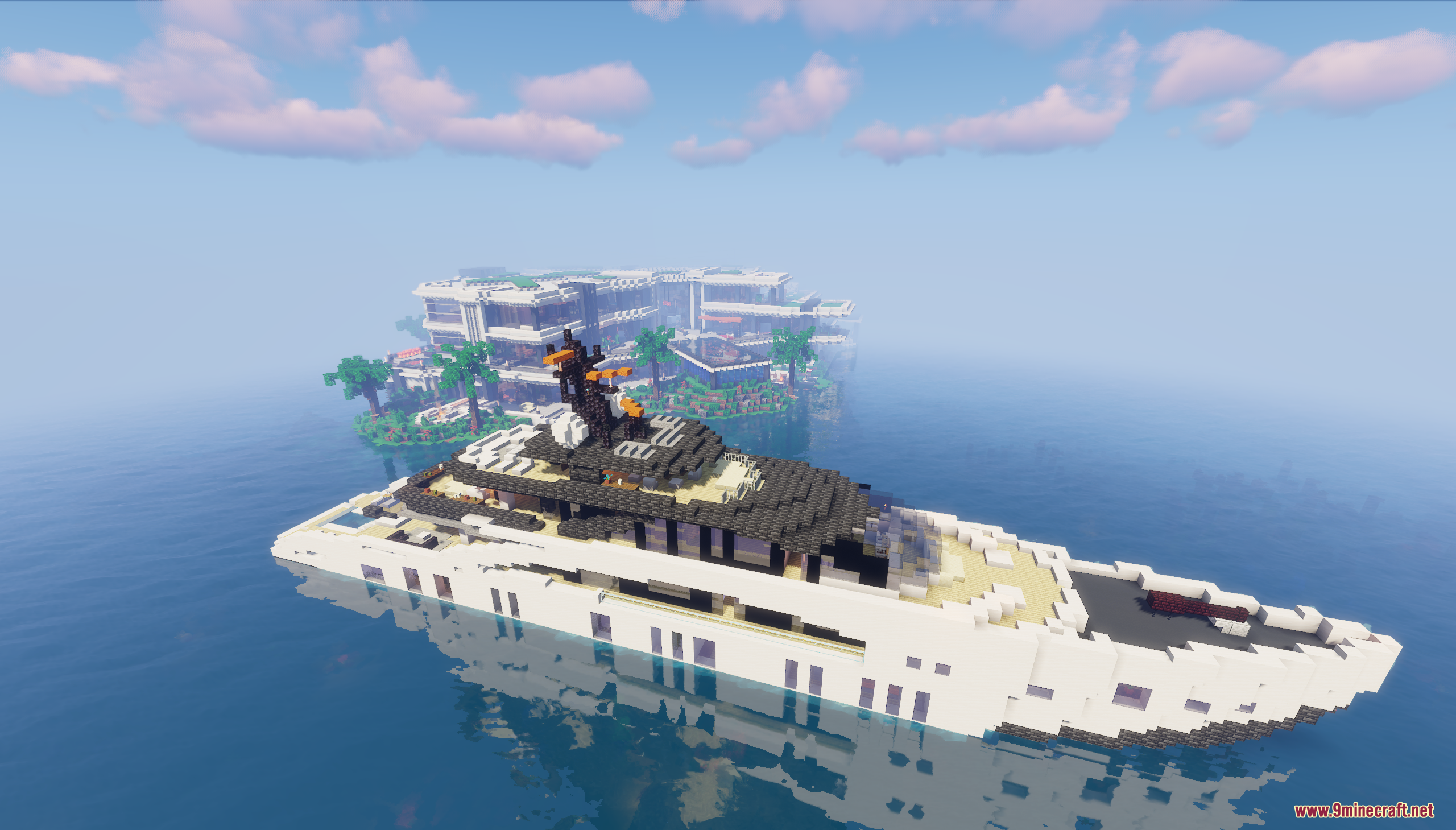 A luxury yacht floats in the ocean near the island