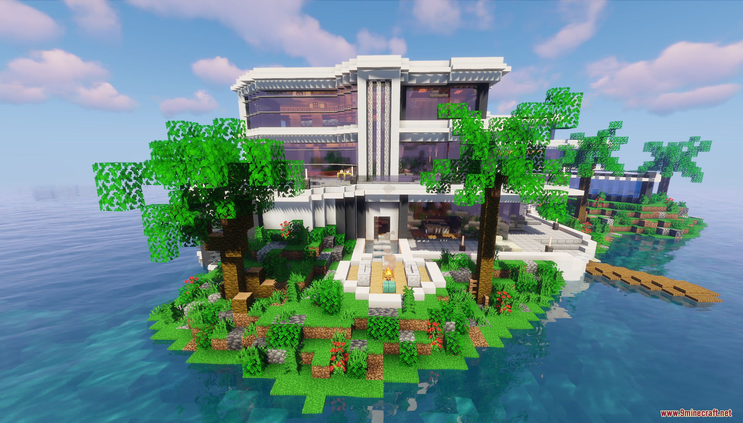 The mansion's entrance is surrounded by lush tropical gardens