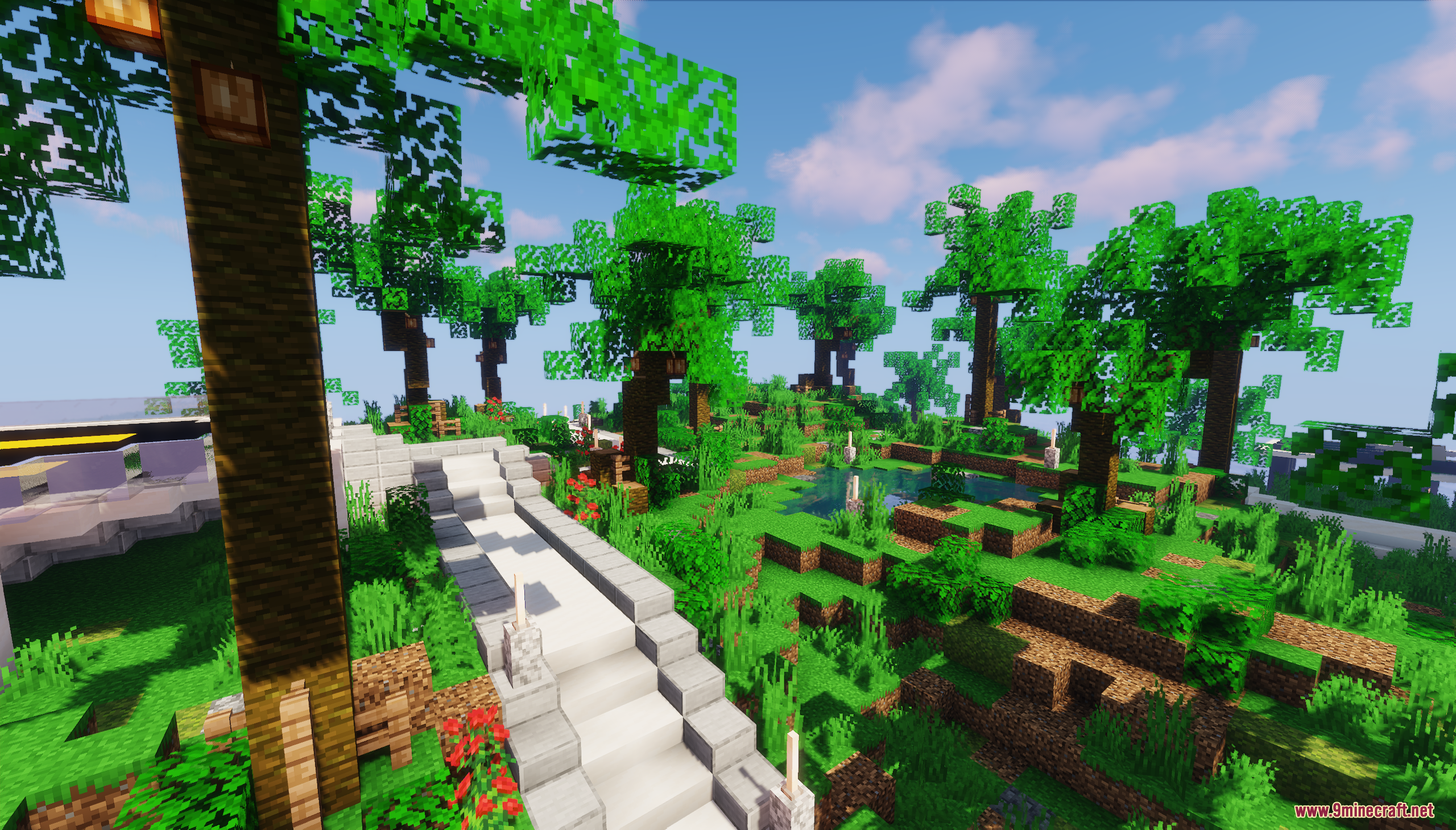 A stone path winds through a lush tropical island garden