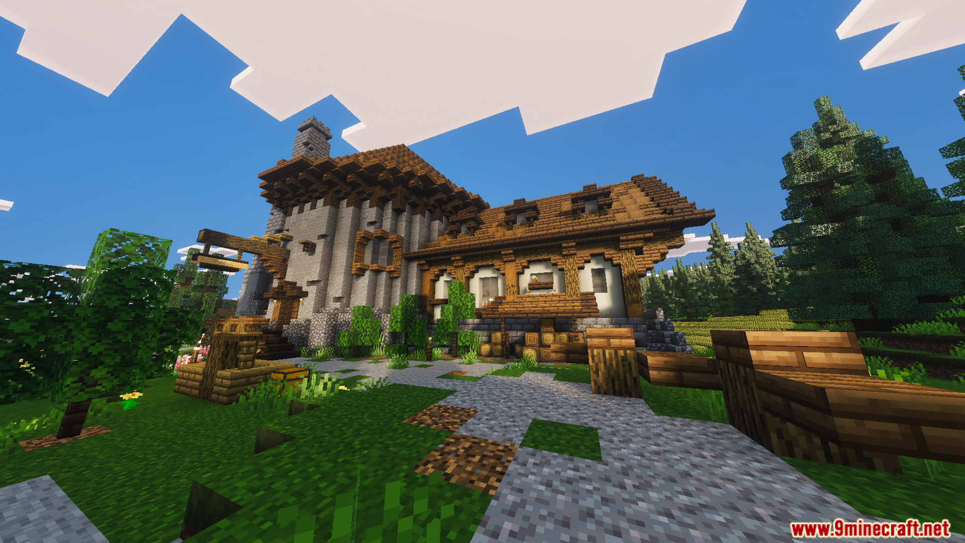 Large medieval tavern with stone walls and wooden features in a rural settlement