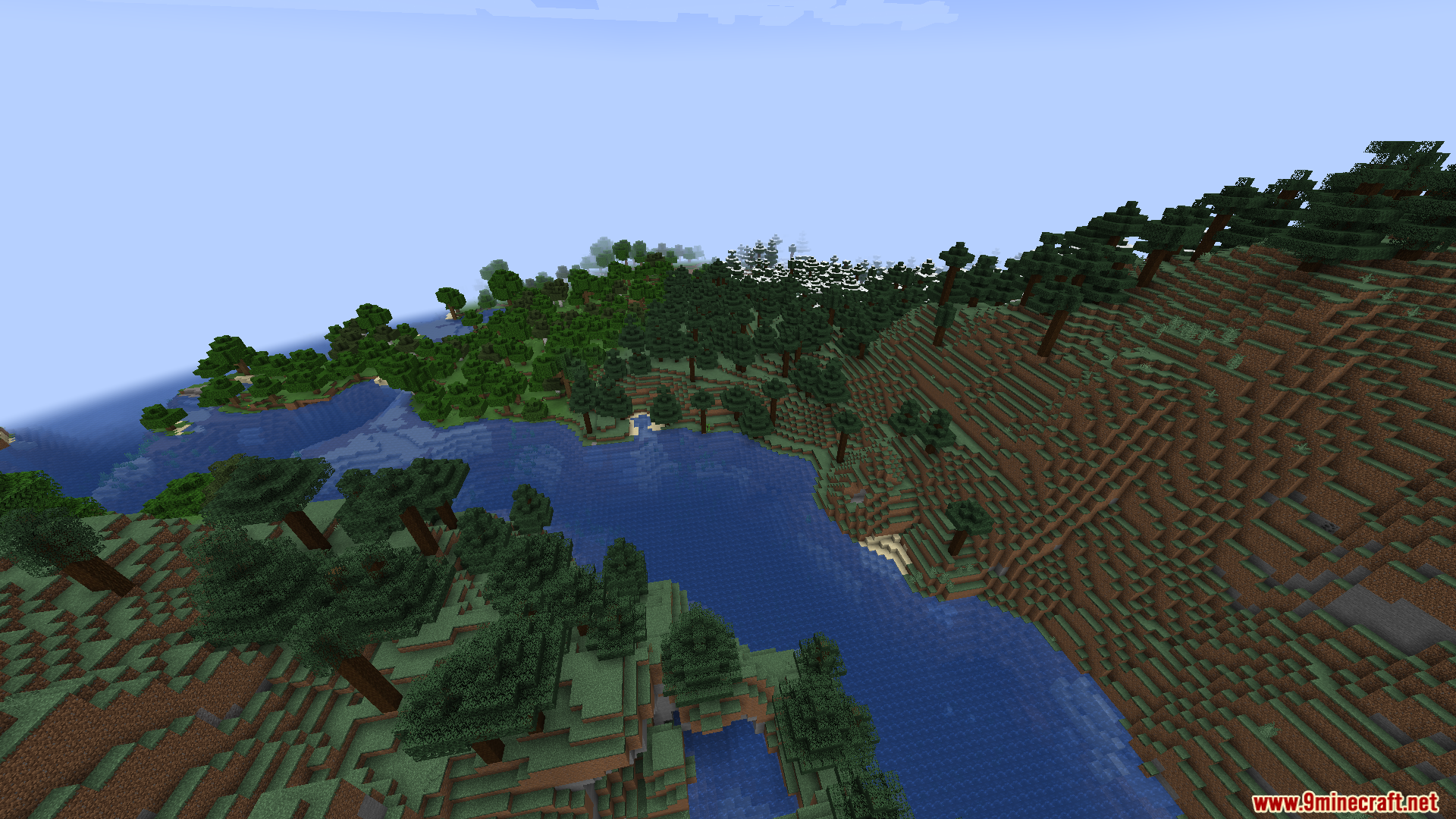 A scenic view of a large lake surrounded by forests
