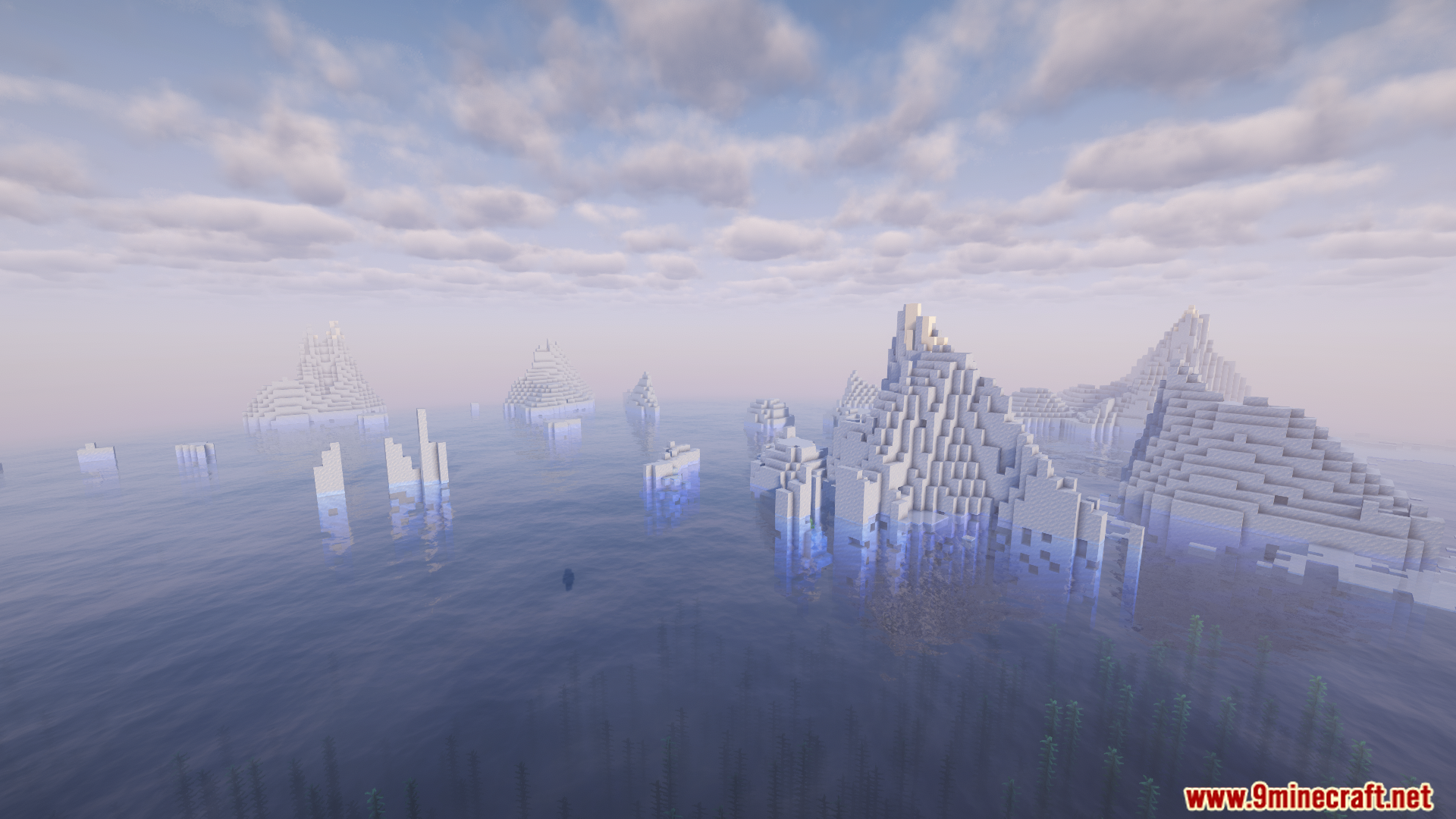 Vast ocean filled with snowy, mountainous icebergs