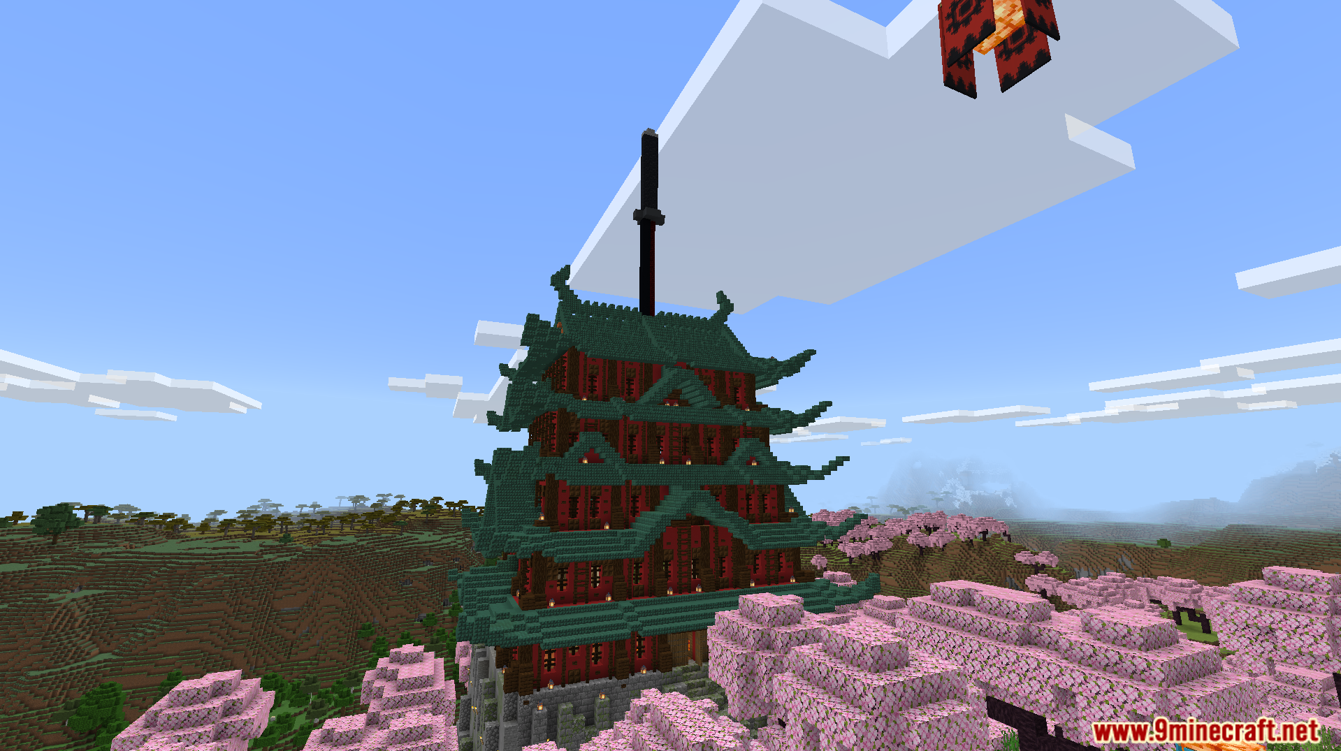 A tall pagoda stands among the pink trees in the biome