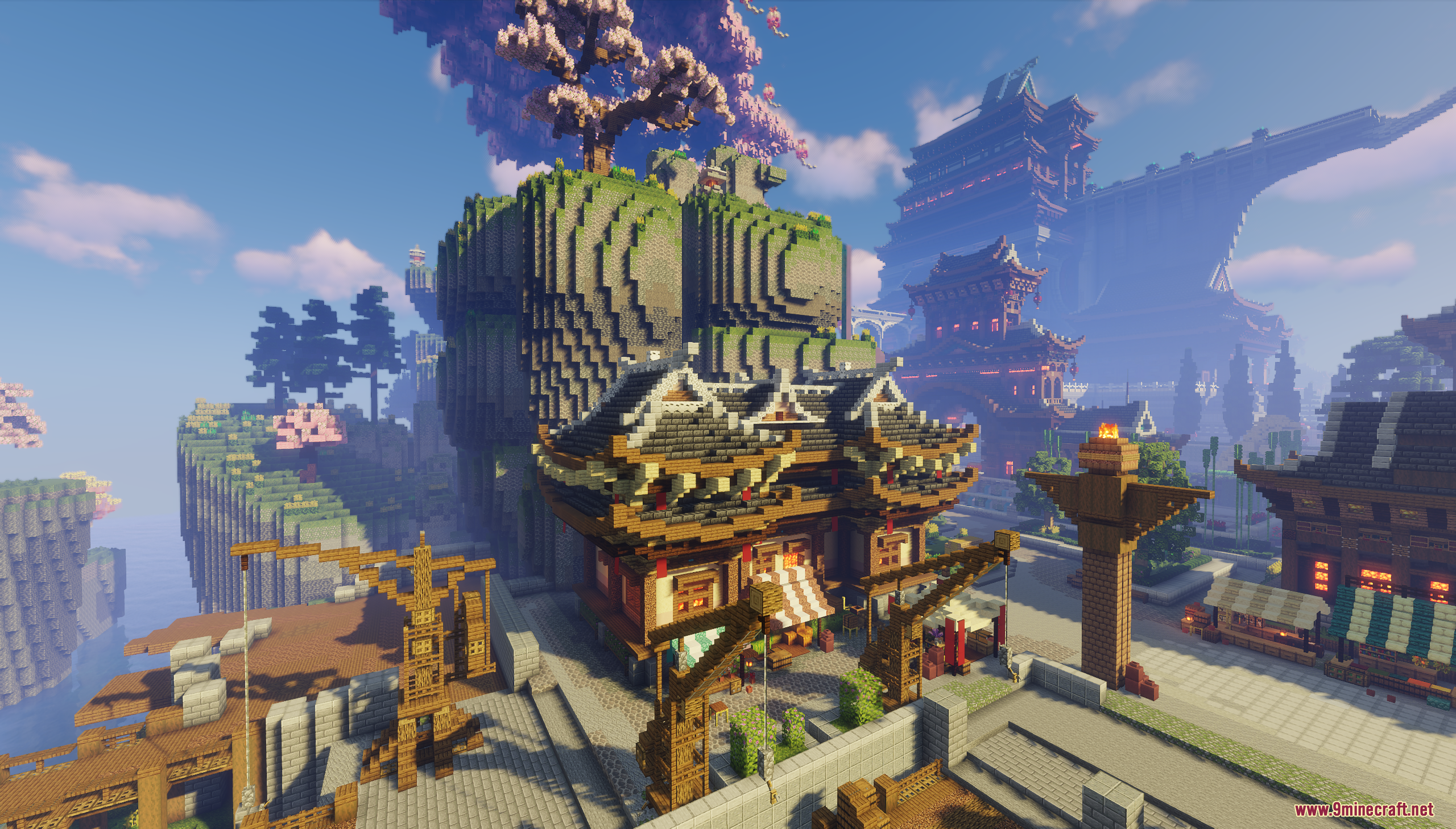 Asian style marketplace with wooden cranes and buildings next to a large cliff