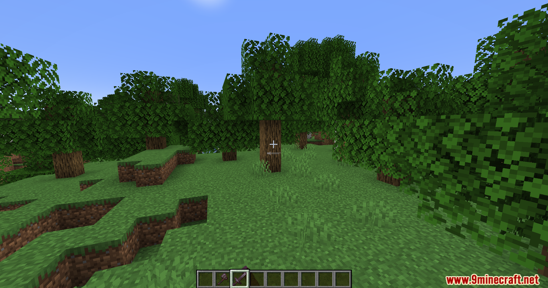 PVP Optimizer Mod Screenshot 10 Player explores a vibrant green forest, holding a weapon, under a clear sky