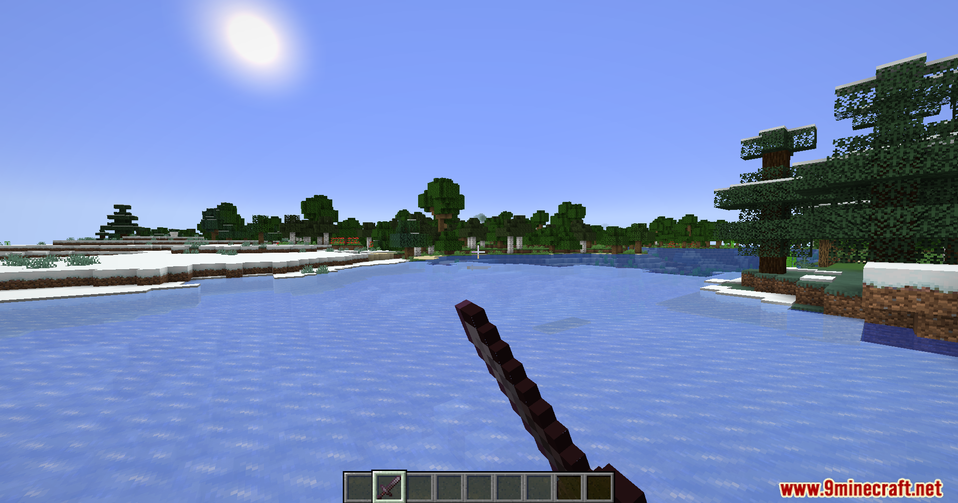 PVP Optimizer Mod Screenshot 4 Player looks across a frozen river at a distant forest under bright sun