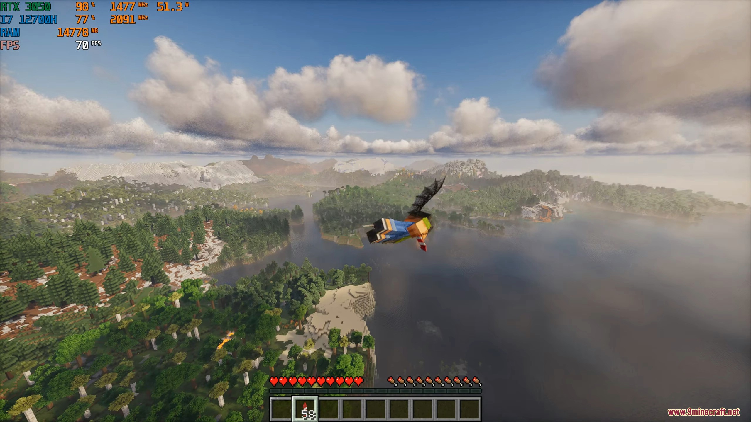 Aerial view of a player gliding over a beautiful forest and lake