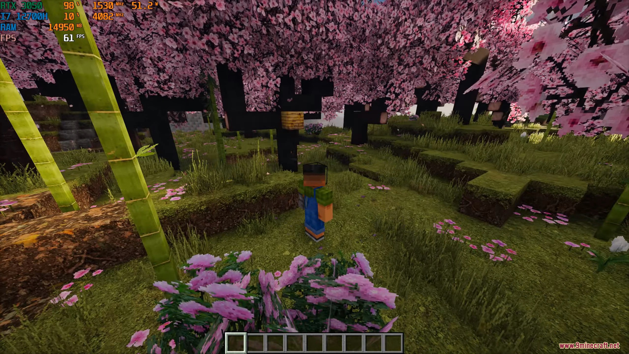 Player character standing in a lush cherry blossom biome with realistic bamboo