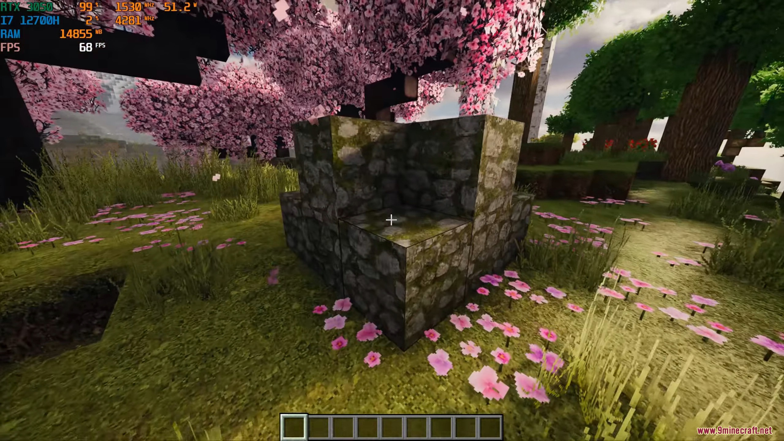Photorealistic mossy cobblestone blocks placed in a vibrant cherry blossom forest biome