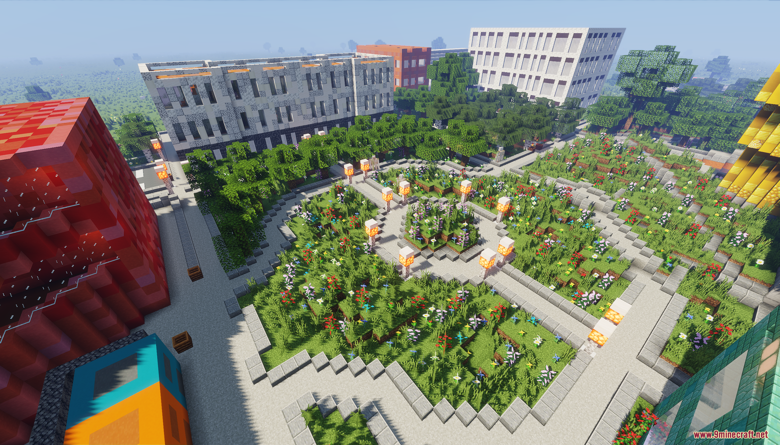 Aerial view of a detailed city park with paths flowers and surrounding buildings