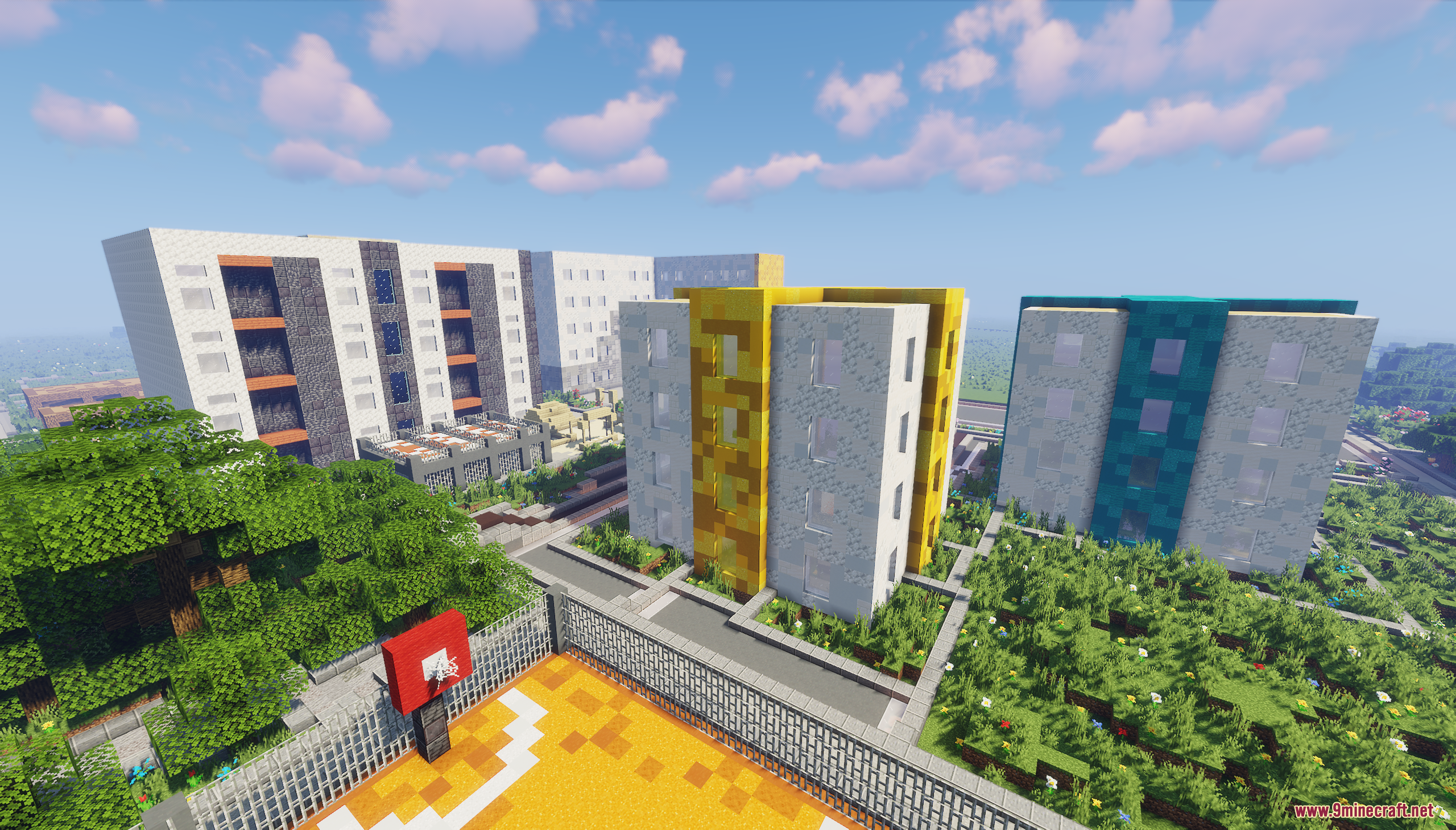 Elevated view showing colorful modern apartment buildings next to a basketball court