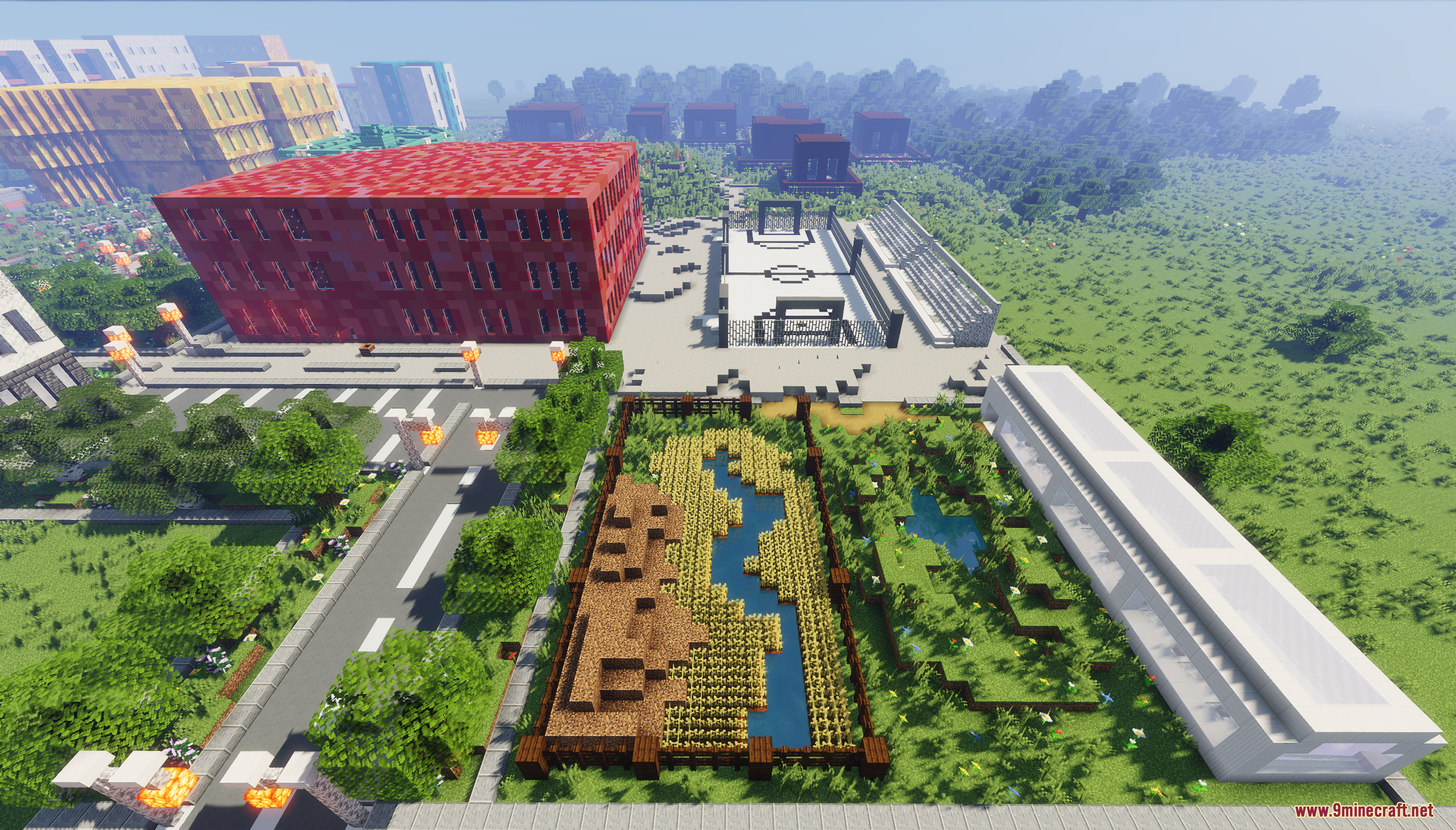 Aerial view of a modern city with a red building and white basketball court