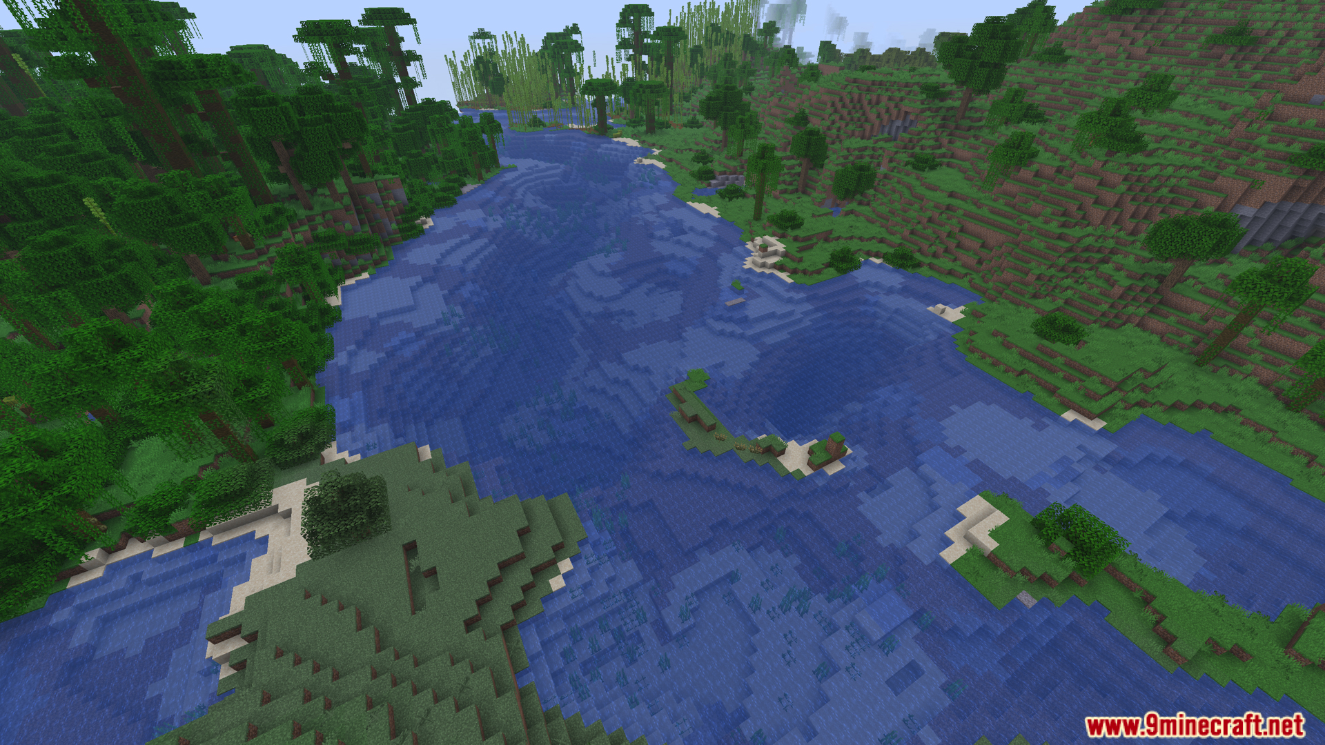 A wide river flowing through a lush green landscape
