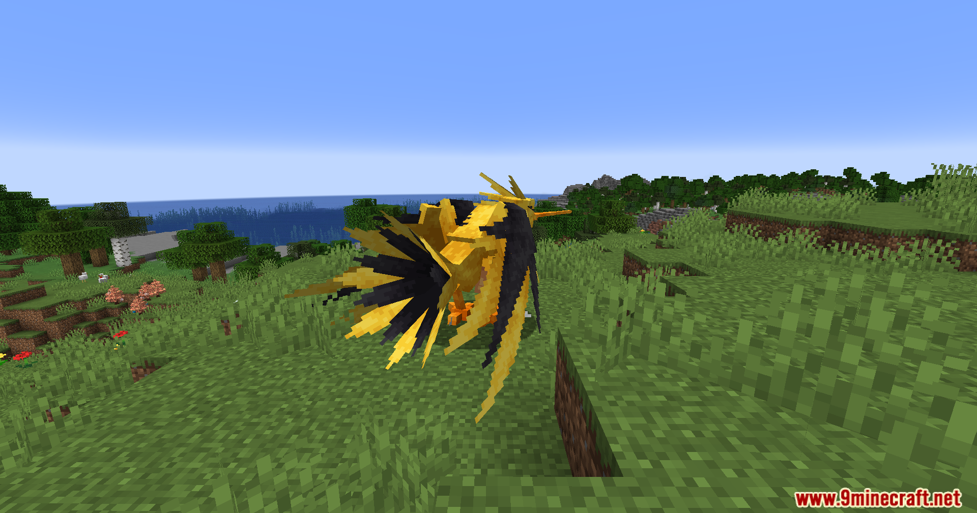 Radiant Notification Cobblemon Addon Mod Screenshot 9 A yellow legendary bird creature standing on a grassy hill near water
