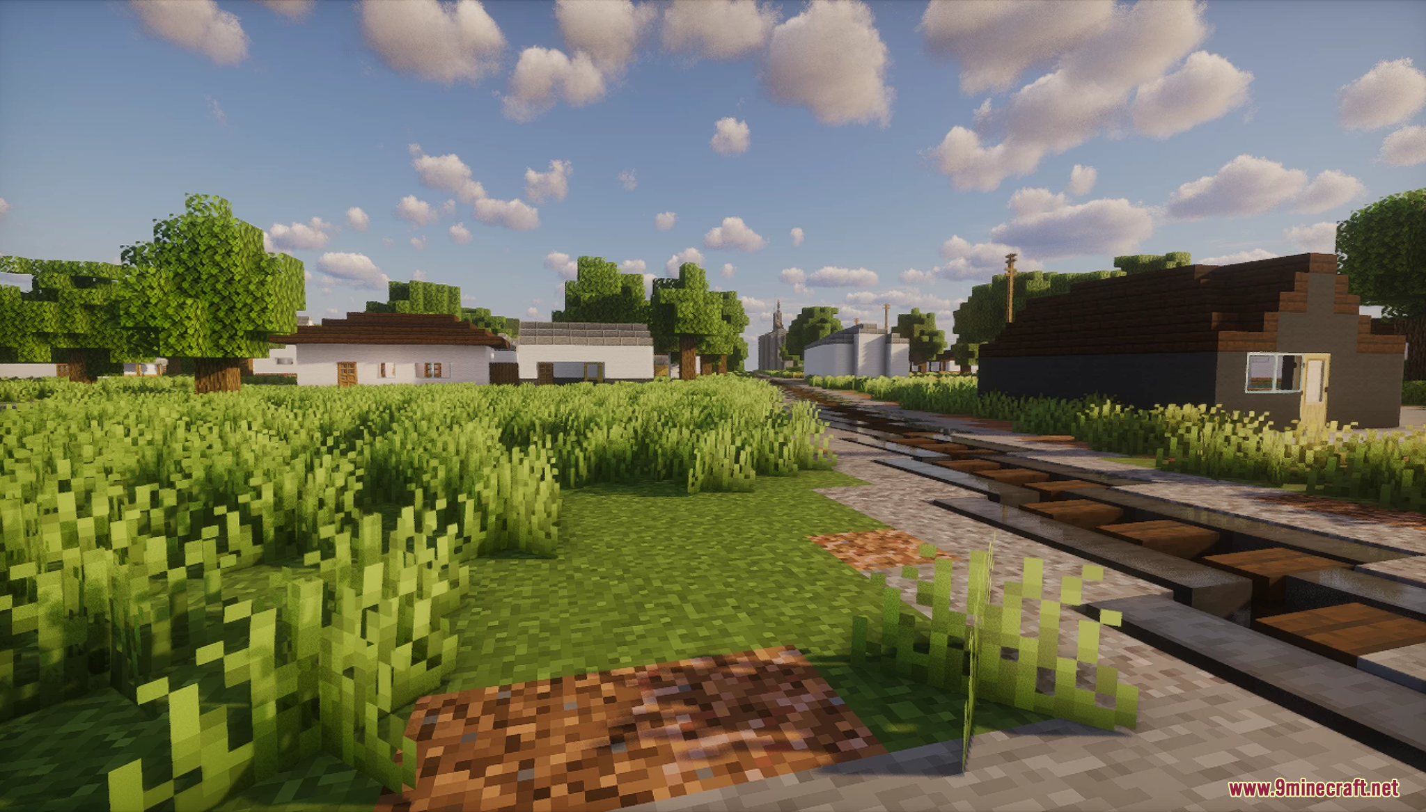 A railroad track running through a rural Minecraft town