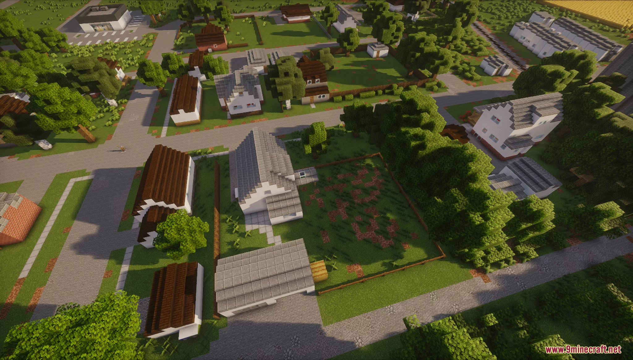 Top-down view of suburban houses with large green yards