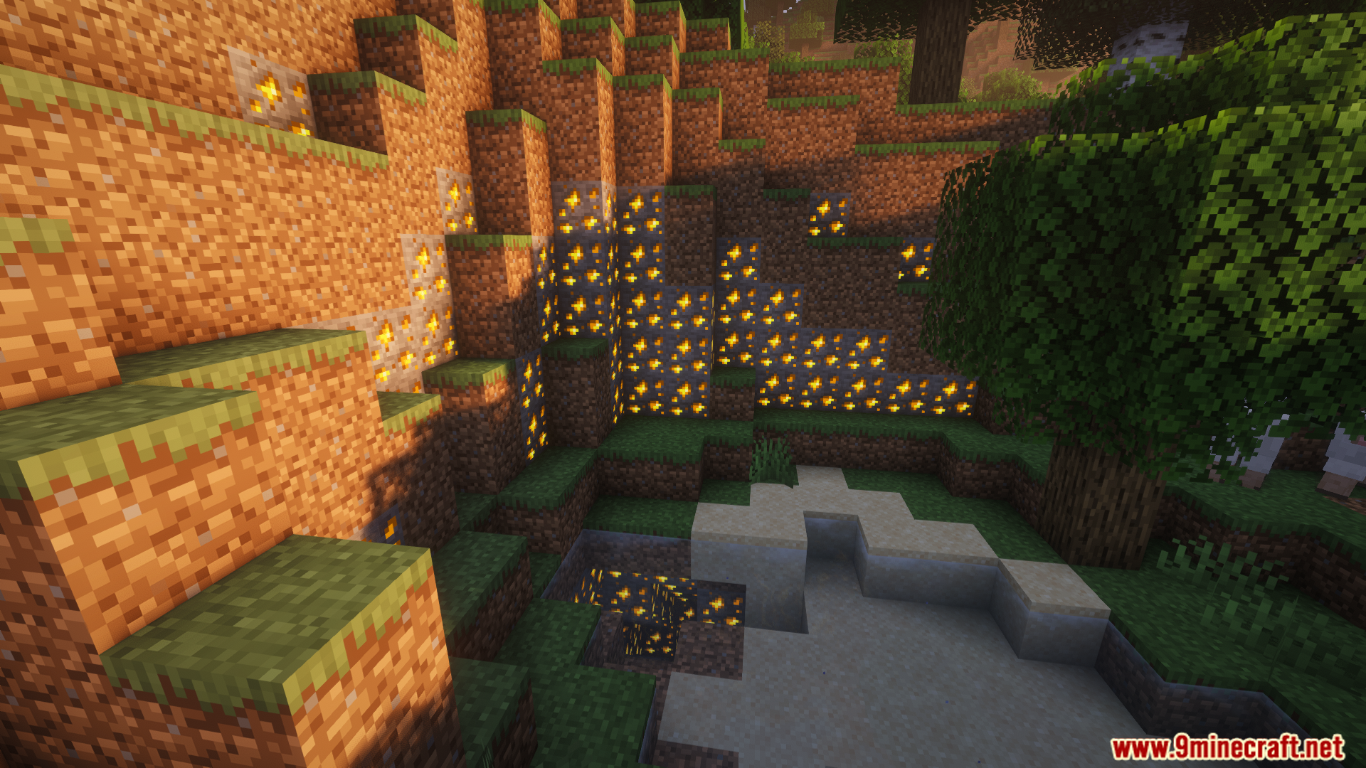Glowing ore blocks replacing dirt on a grassy cliffside