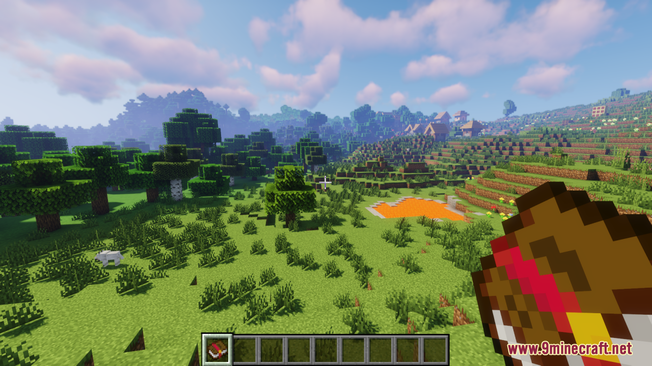 Player holding an enchanted book in a scenic landscape