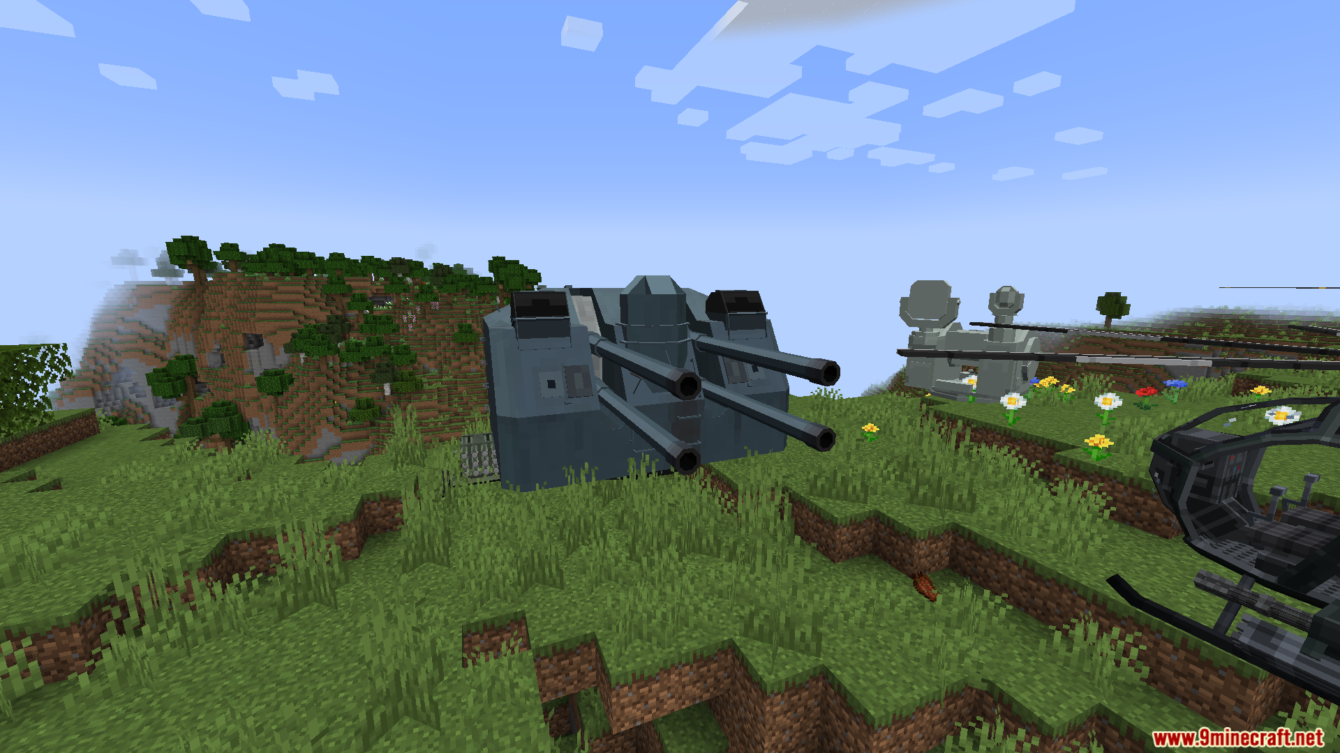 A large four-barreled naval gun turret on land