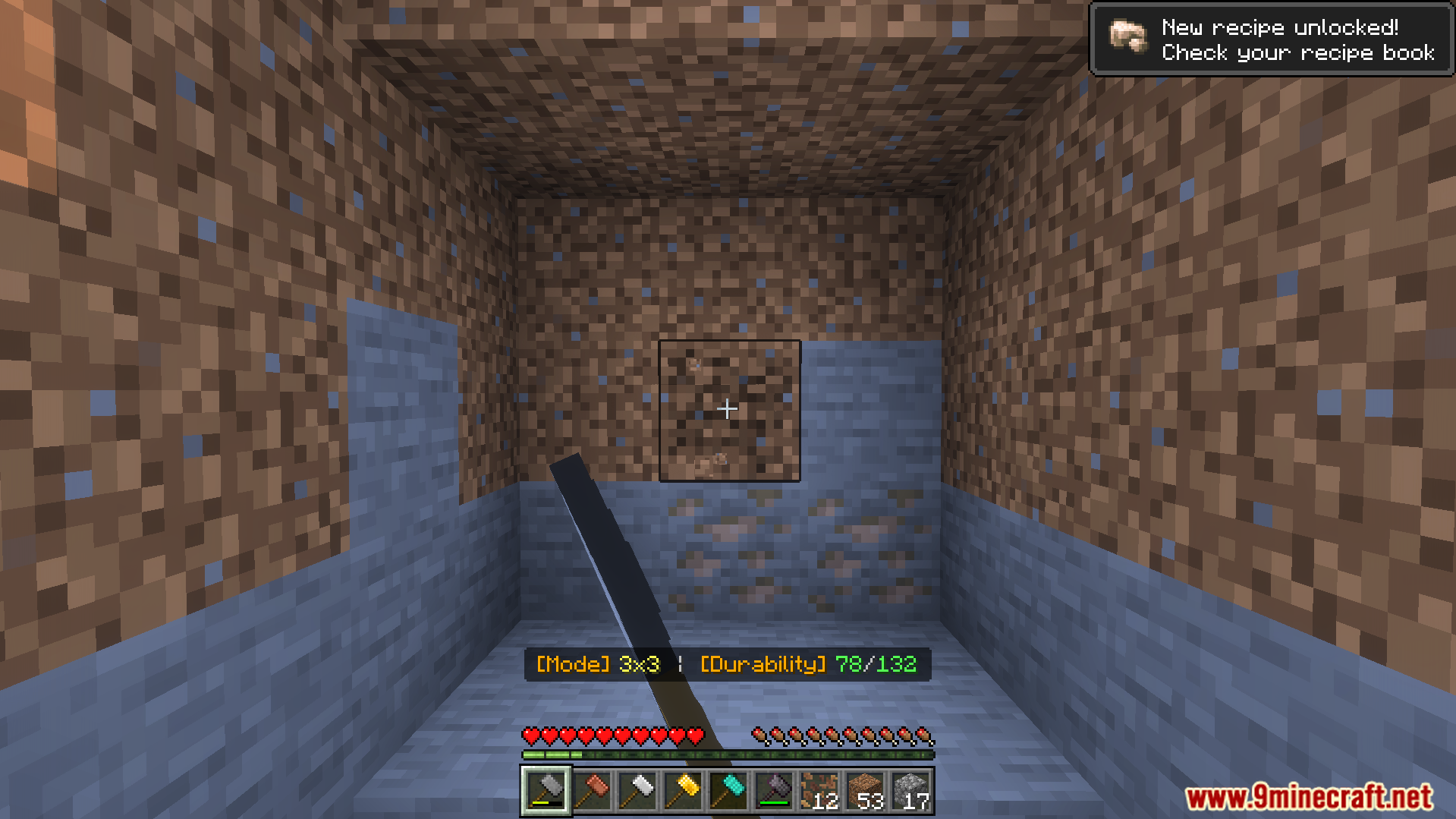 Player holding a hammer tool facing a dirt wall