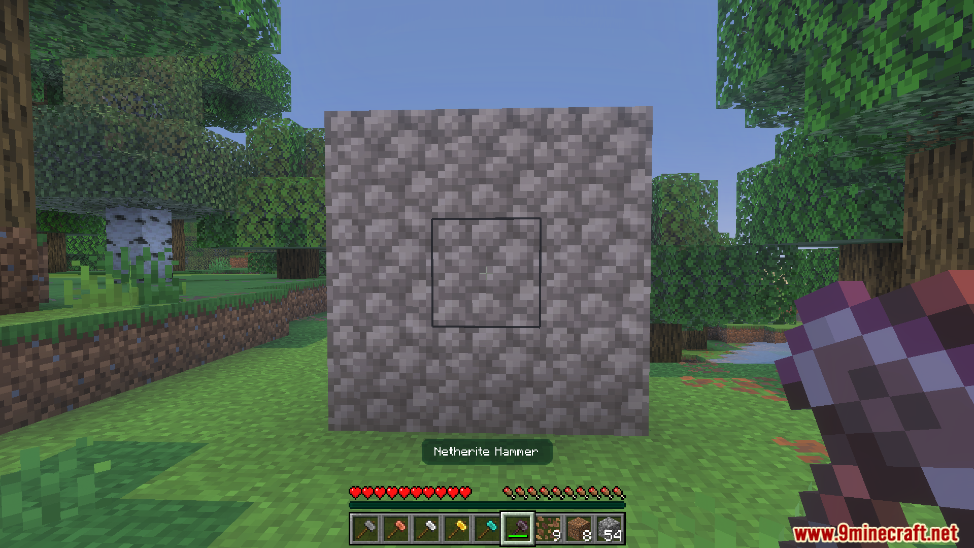 Simple Hammers Addon Screenshot 6 Player holding a netherite hammer facing a three by three wall of cobblestone