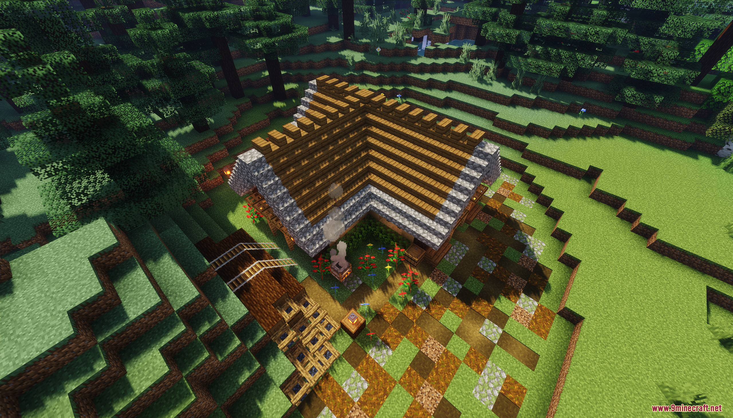 Aerial view of the L shaped wooden starter house and yard