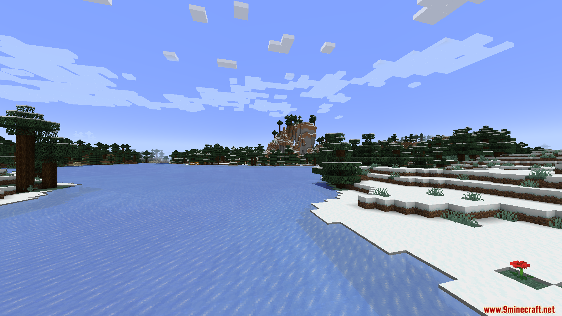 Smart FPS Booster Mod Screenshot 10 A wide view of a frozen lake surrounded by snow and spruce trees