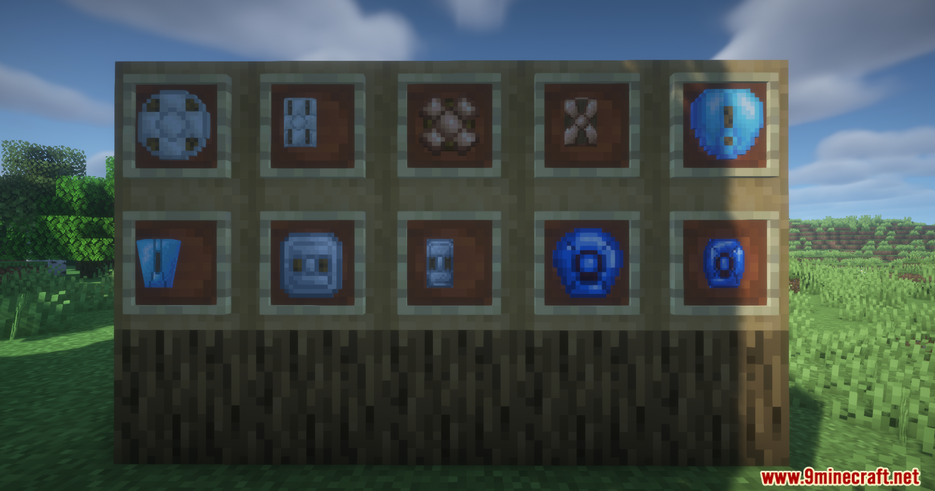 Various custom shields displayed in item frames on a wall