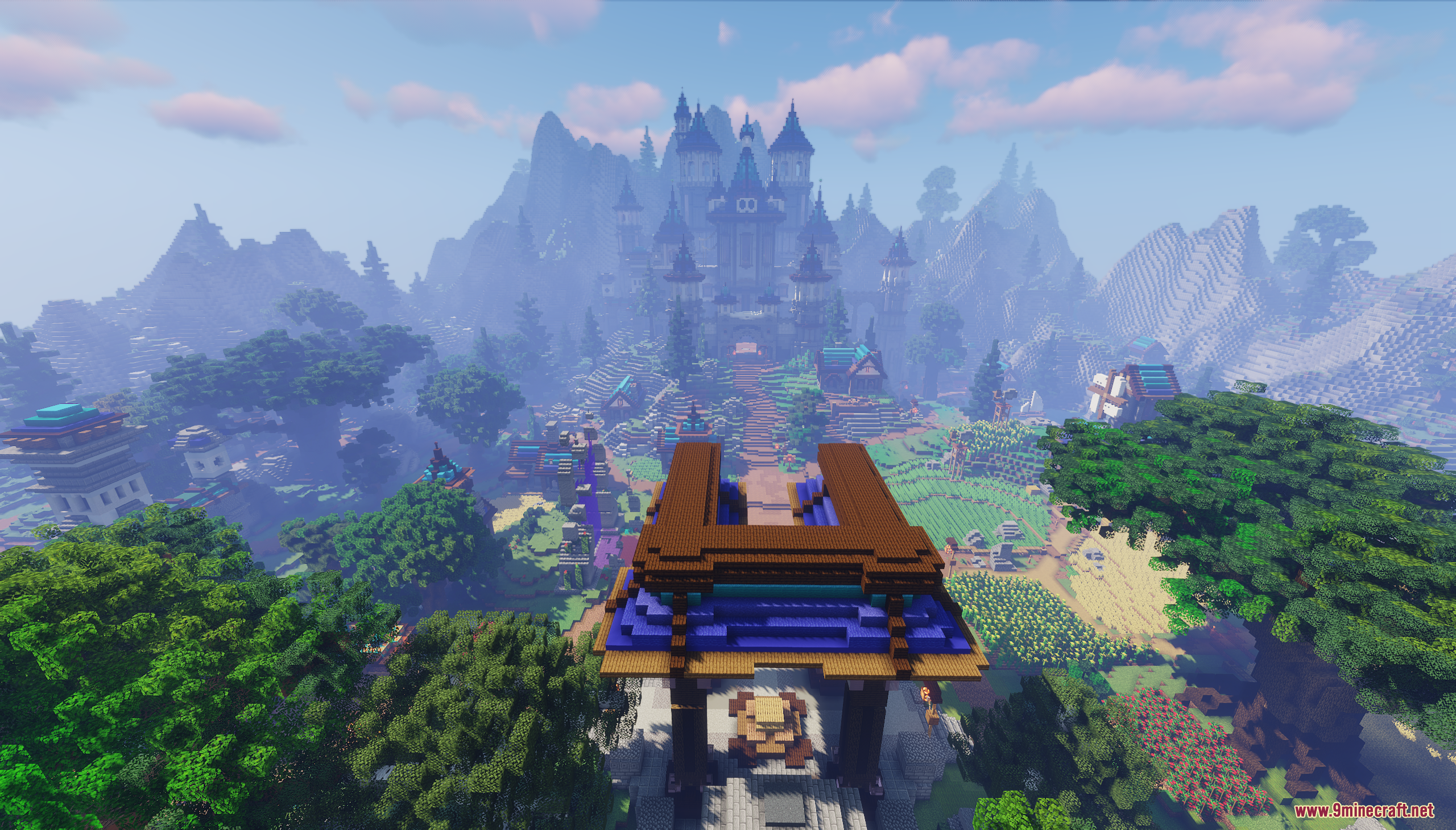 Looking through a large wooden gate towards a distant castle and village