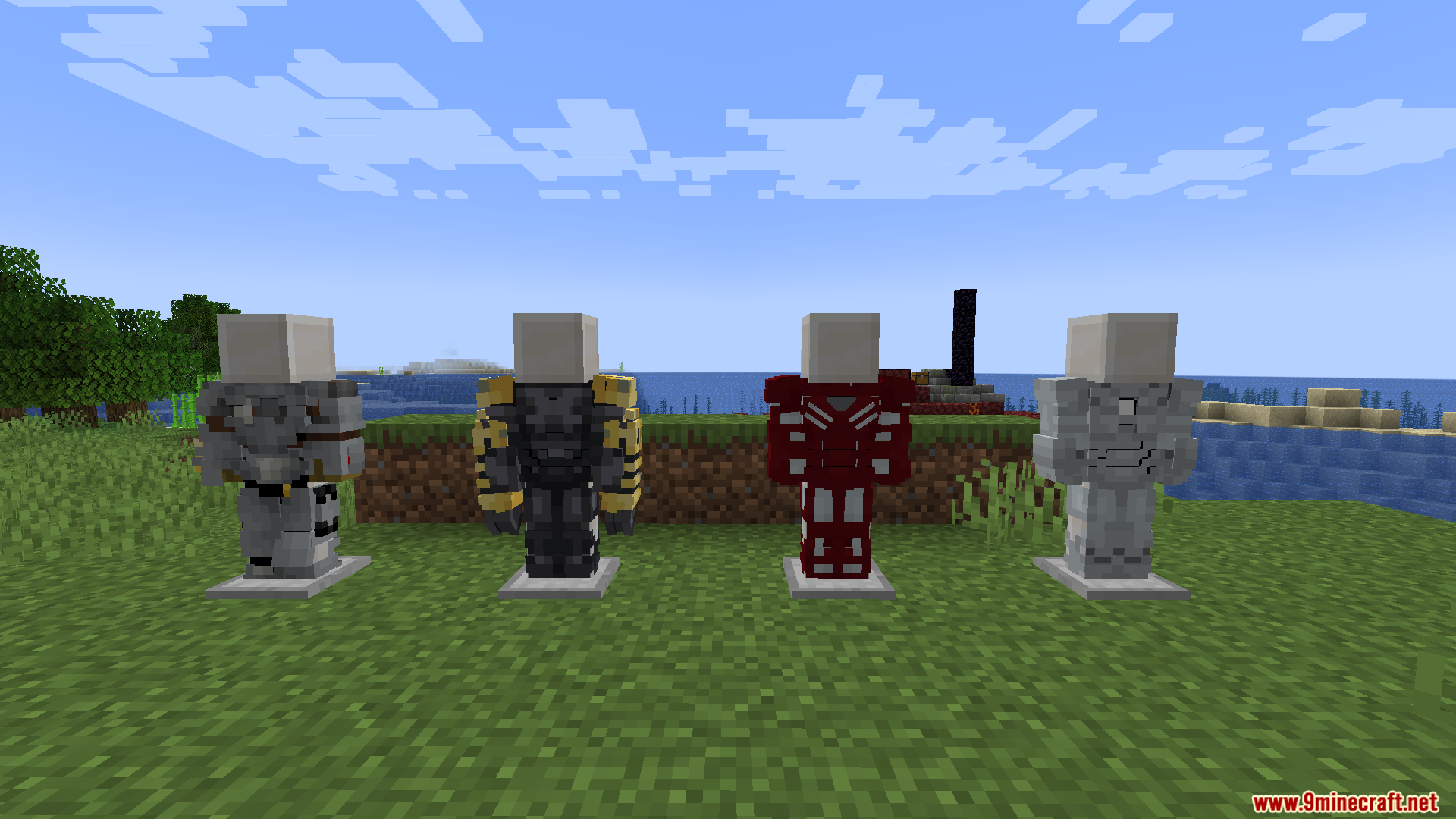 Four different superhero armor suits displayed on stands in a grassy field