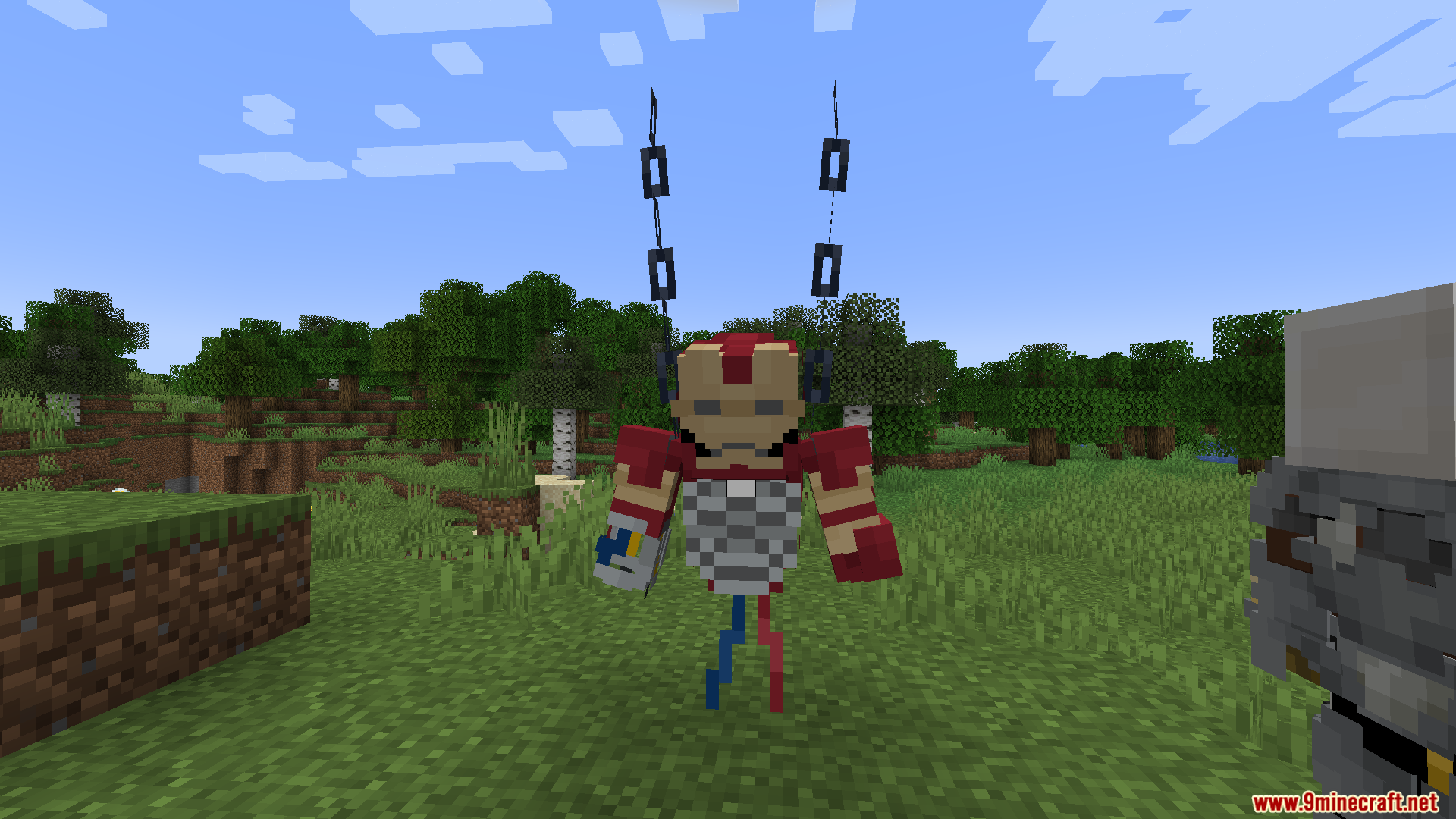Player character suspended by chains wearing a partially assembled red superhero suit