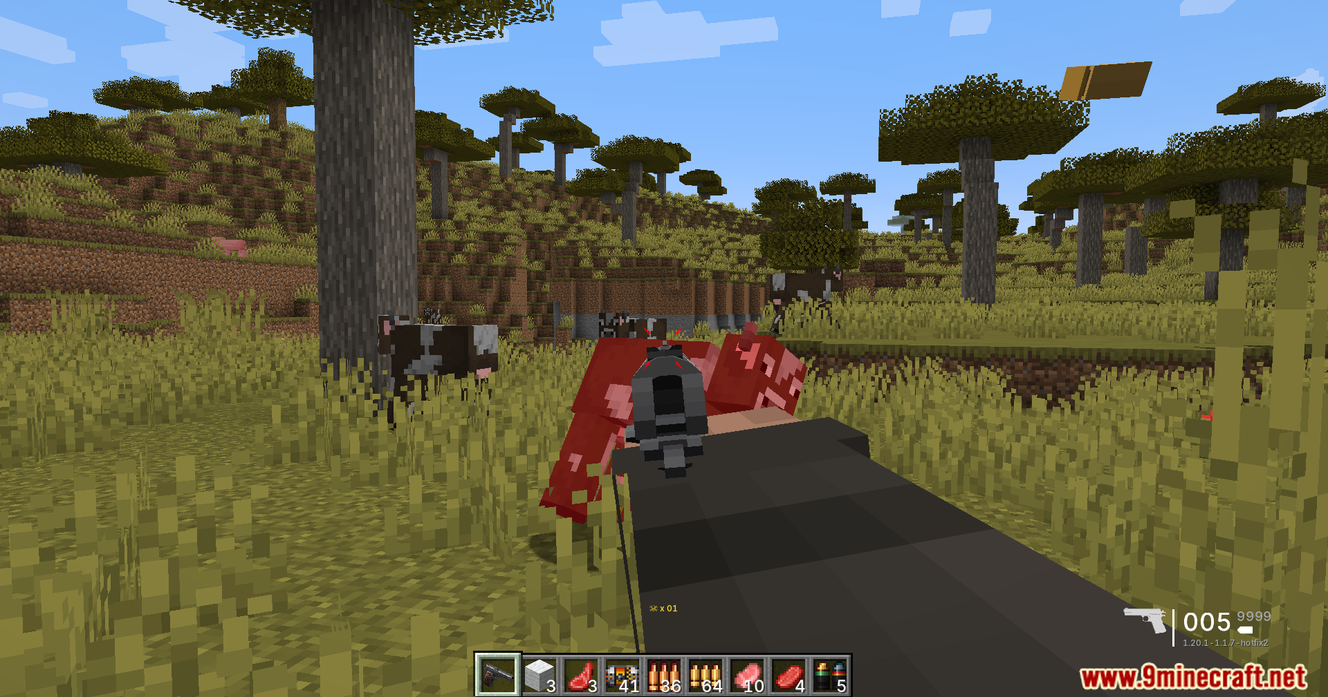 TaCZ Bullets Back Mod Screenshot 10 Player aiming a pistol and shooting a cow in a savanna biome