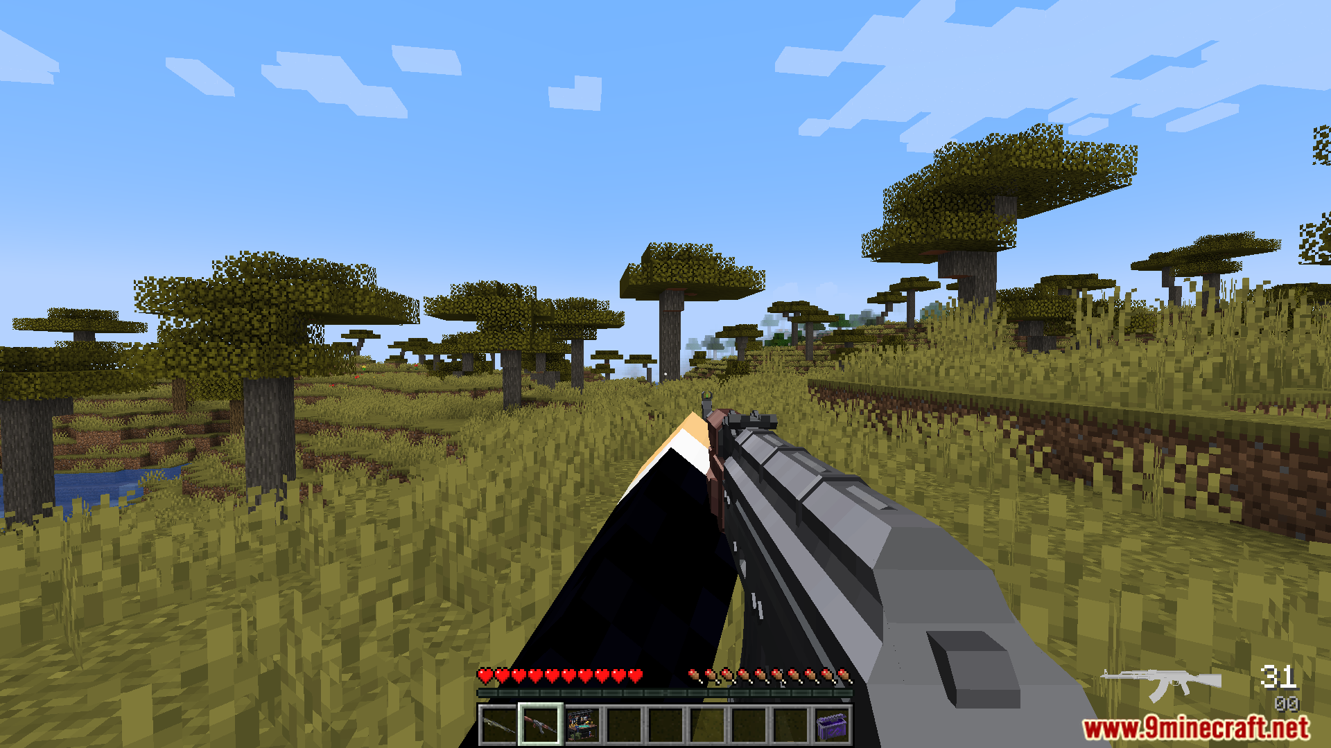Player holding a rifle in a savanna biome