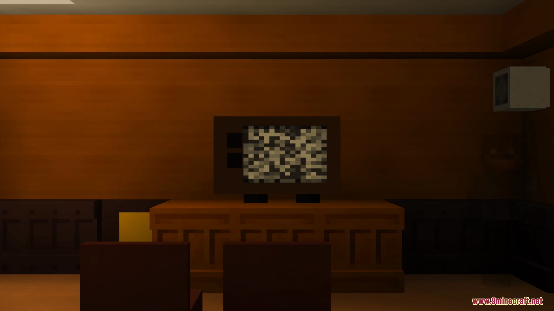 An old television displaying static in a dark wooden room