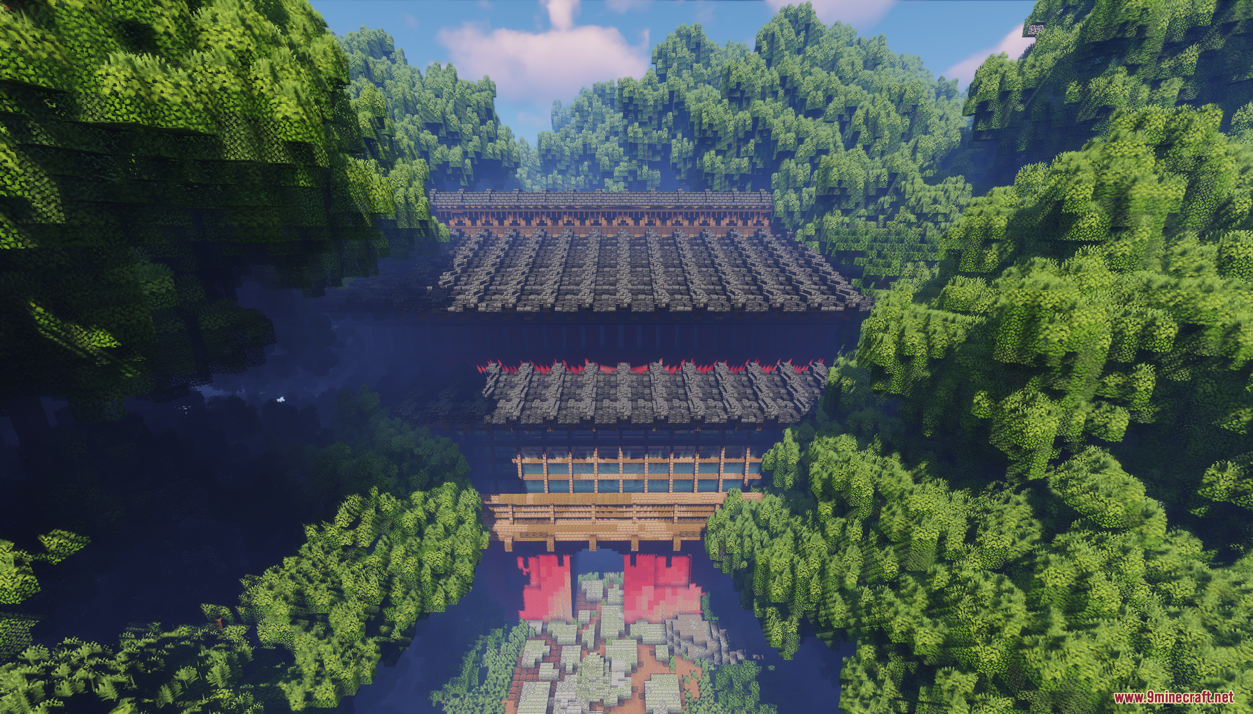 The Red Gate structure nestled within a dense green forest