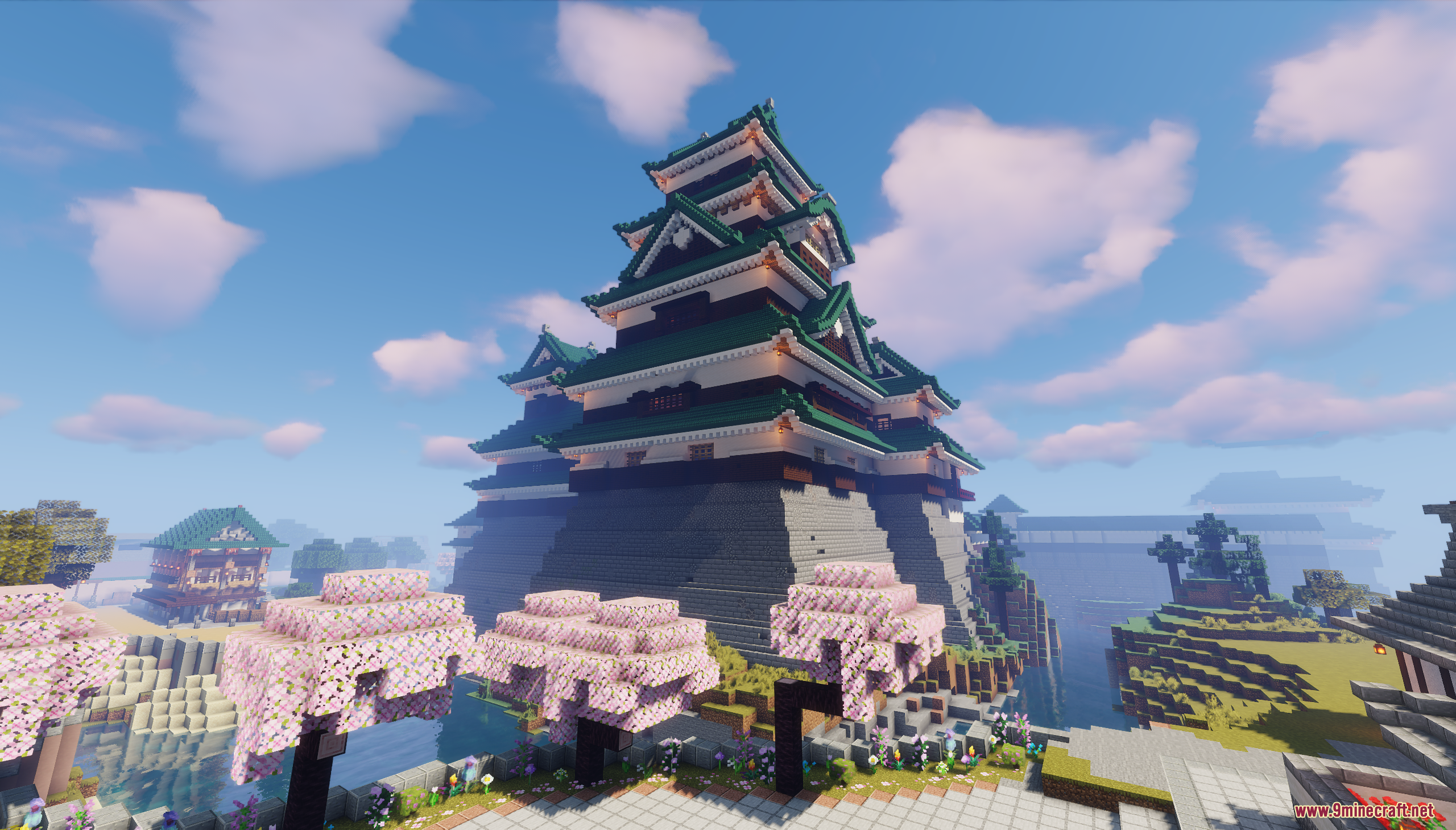 A large Japanese castle surrounded by cherry blossom trees