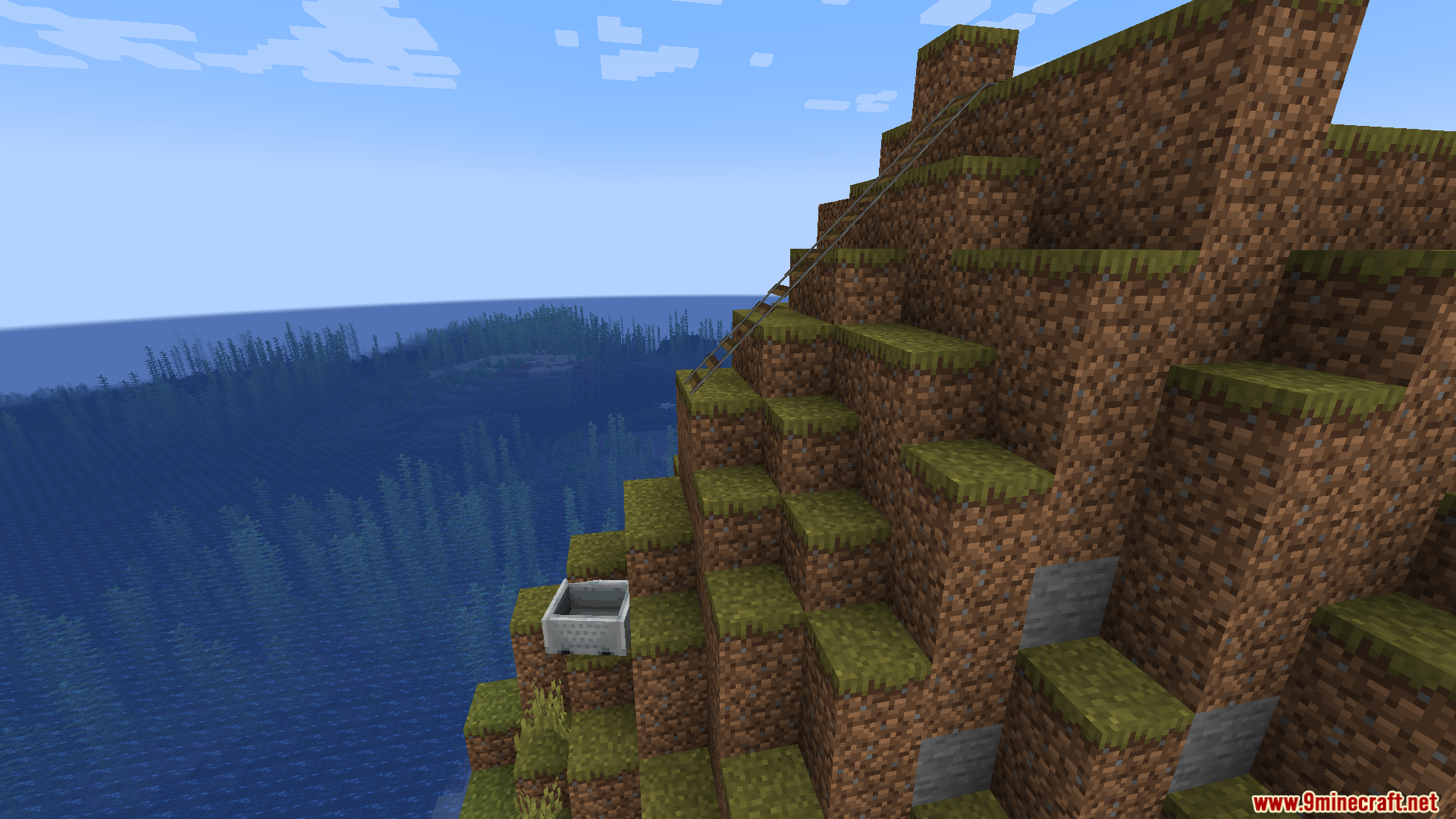 An empty minecart at the bottom of a cliffside railway