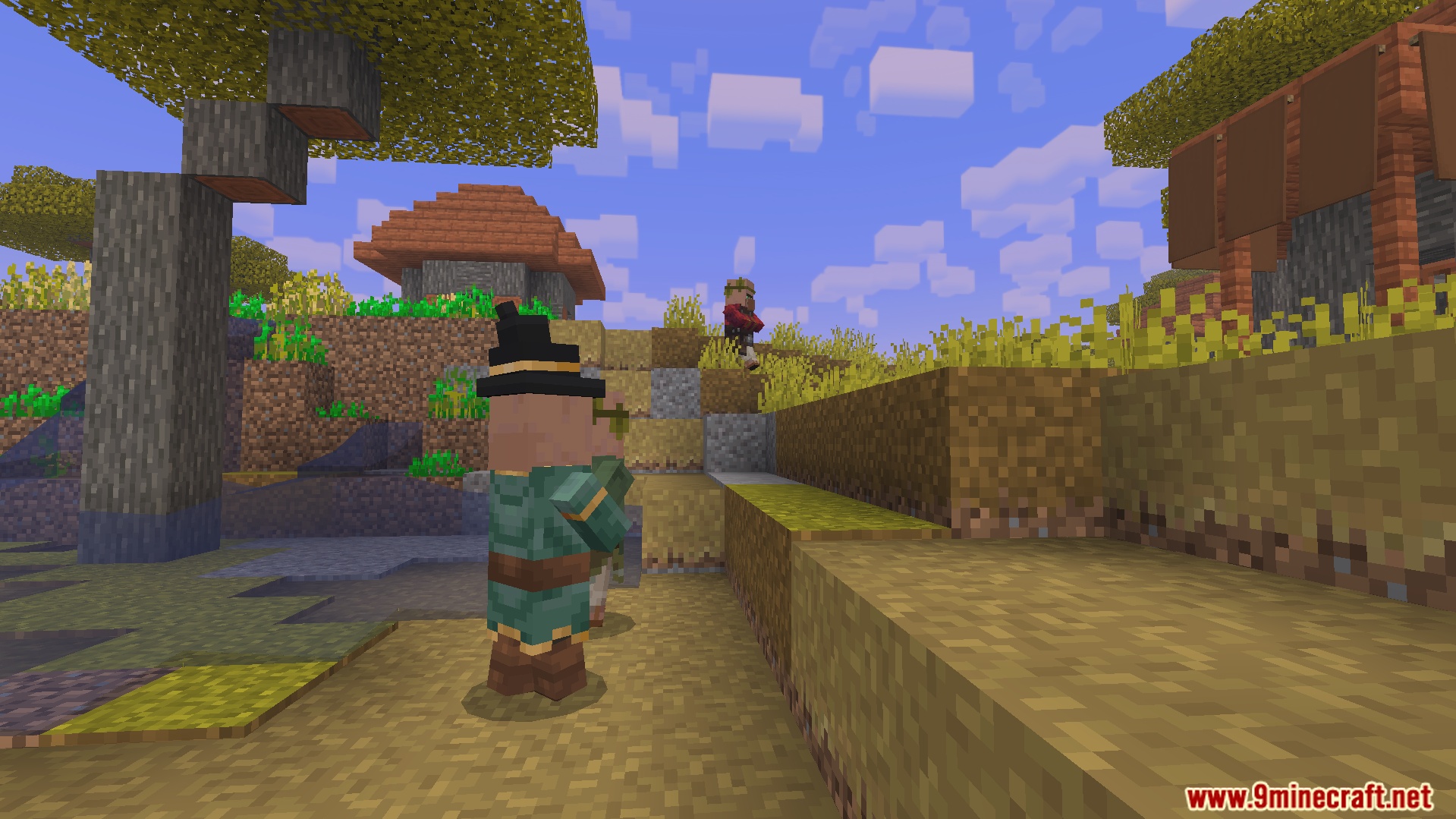villager with a black hat and green outfit in a savanna village