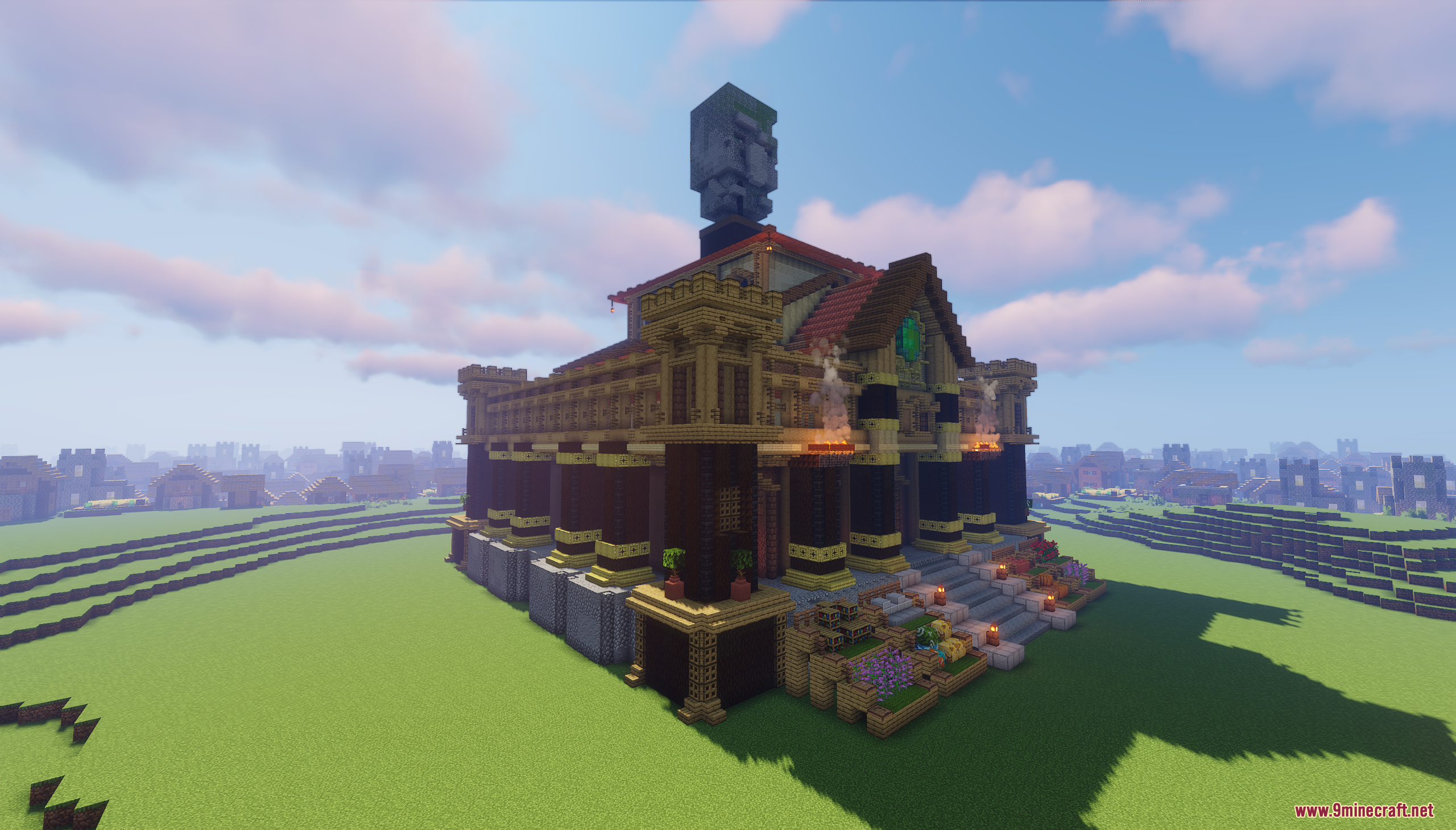 Exterior view of a grand building topped with a giant stone villager head
