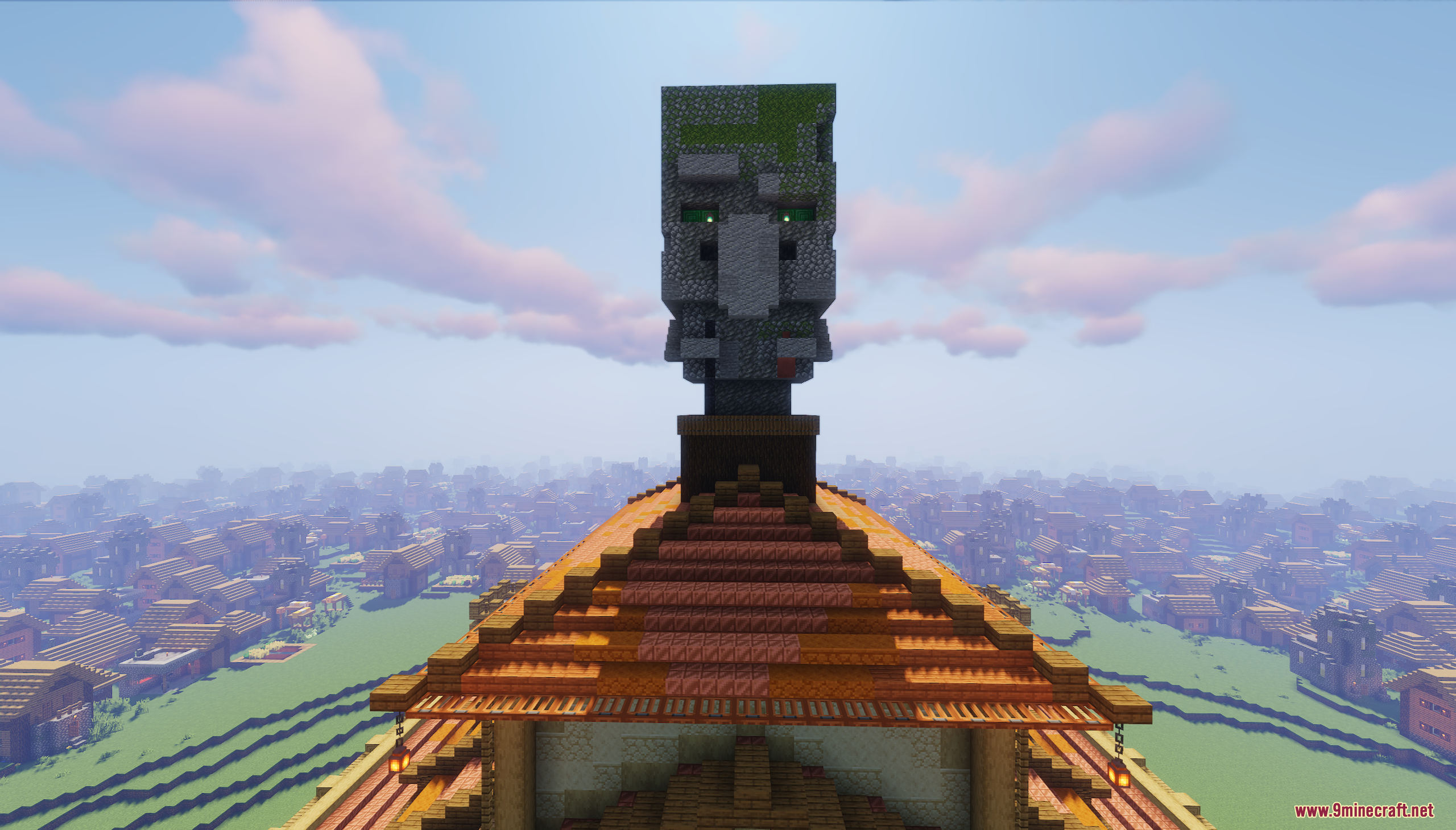 Giant stone villager head statue built on top of a wooden building roof
