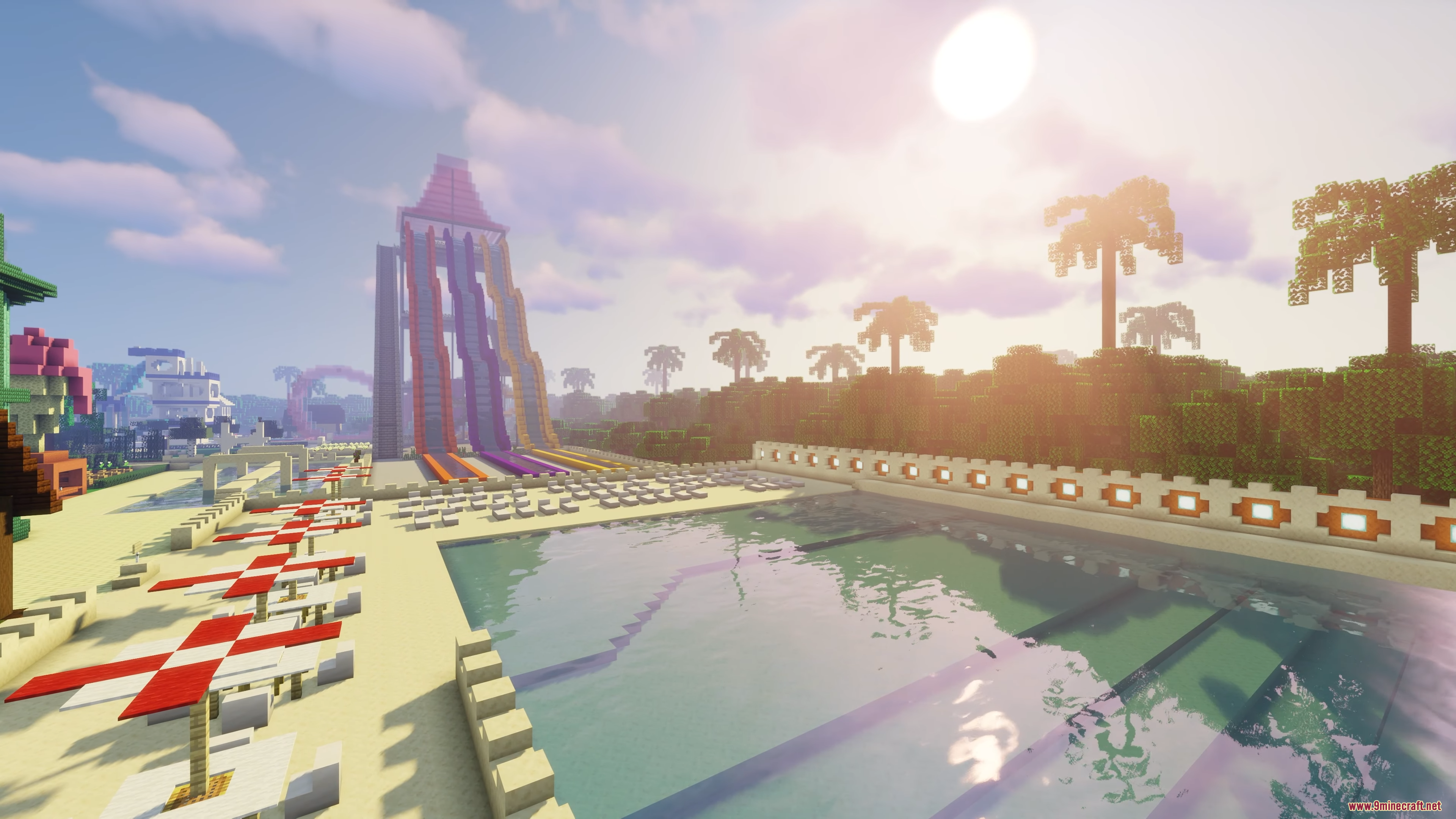 A large swimming pool next to a towering water slide