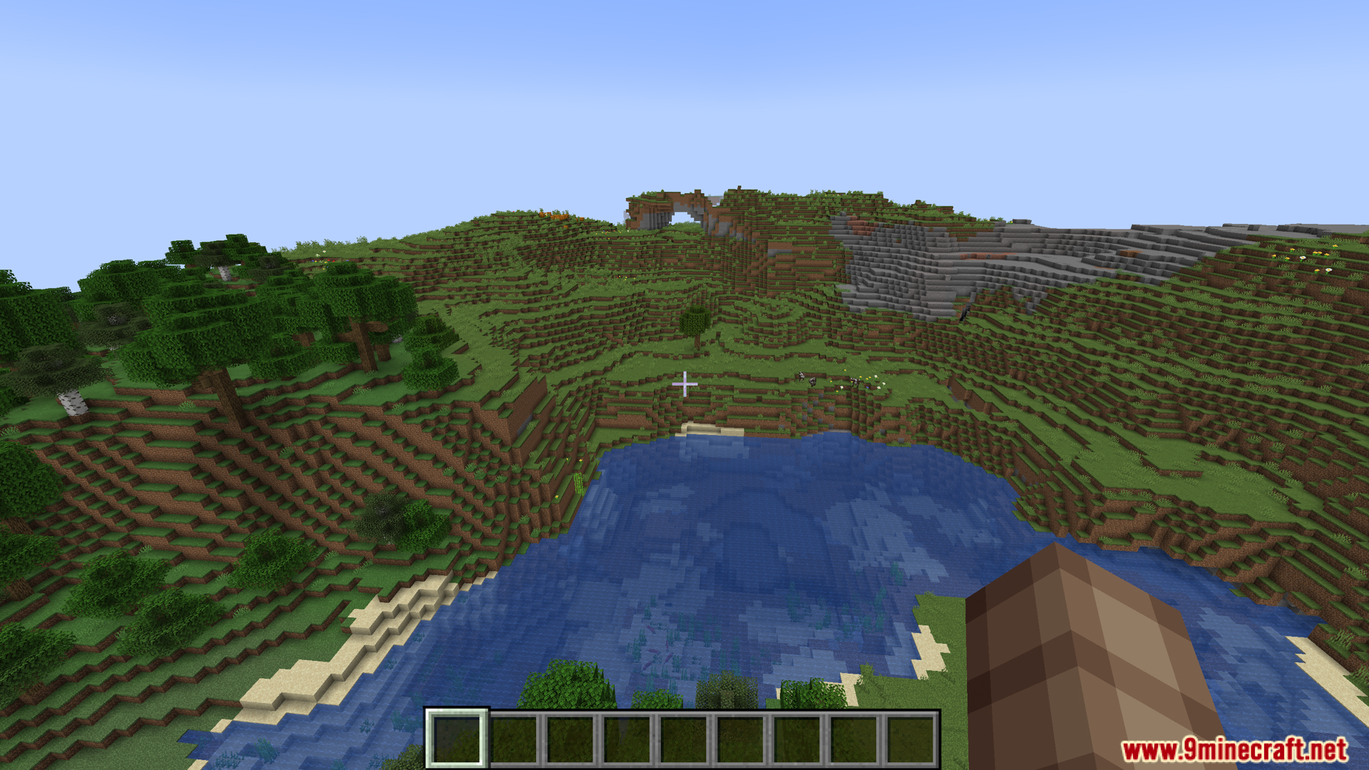 A scenic view of a lake and hilly terrain