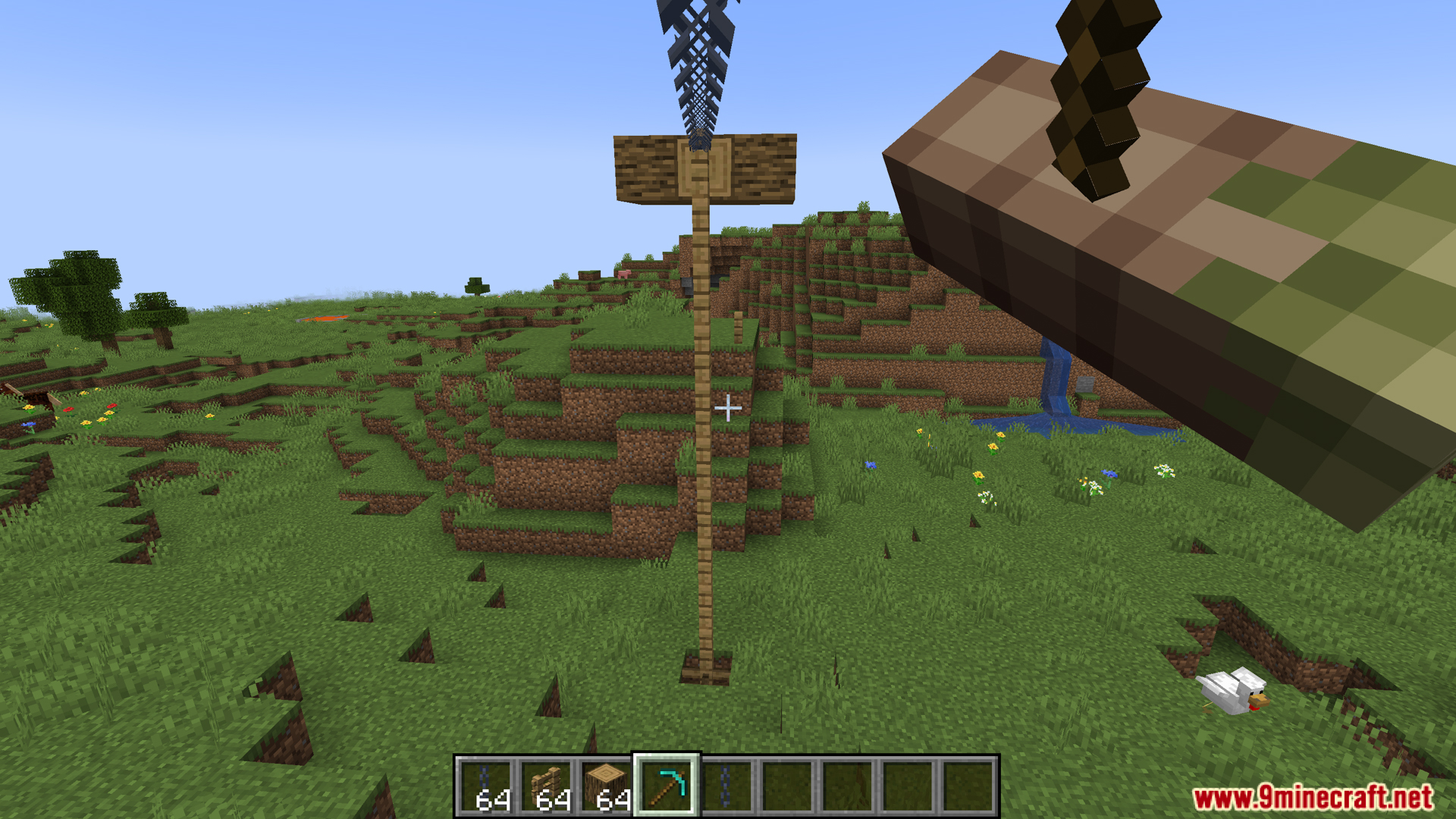 A tall wooden zipline pole with a long chain
