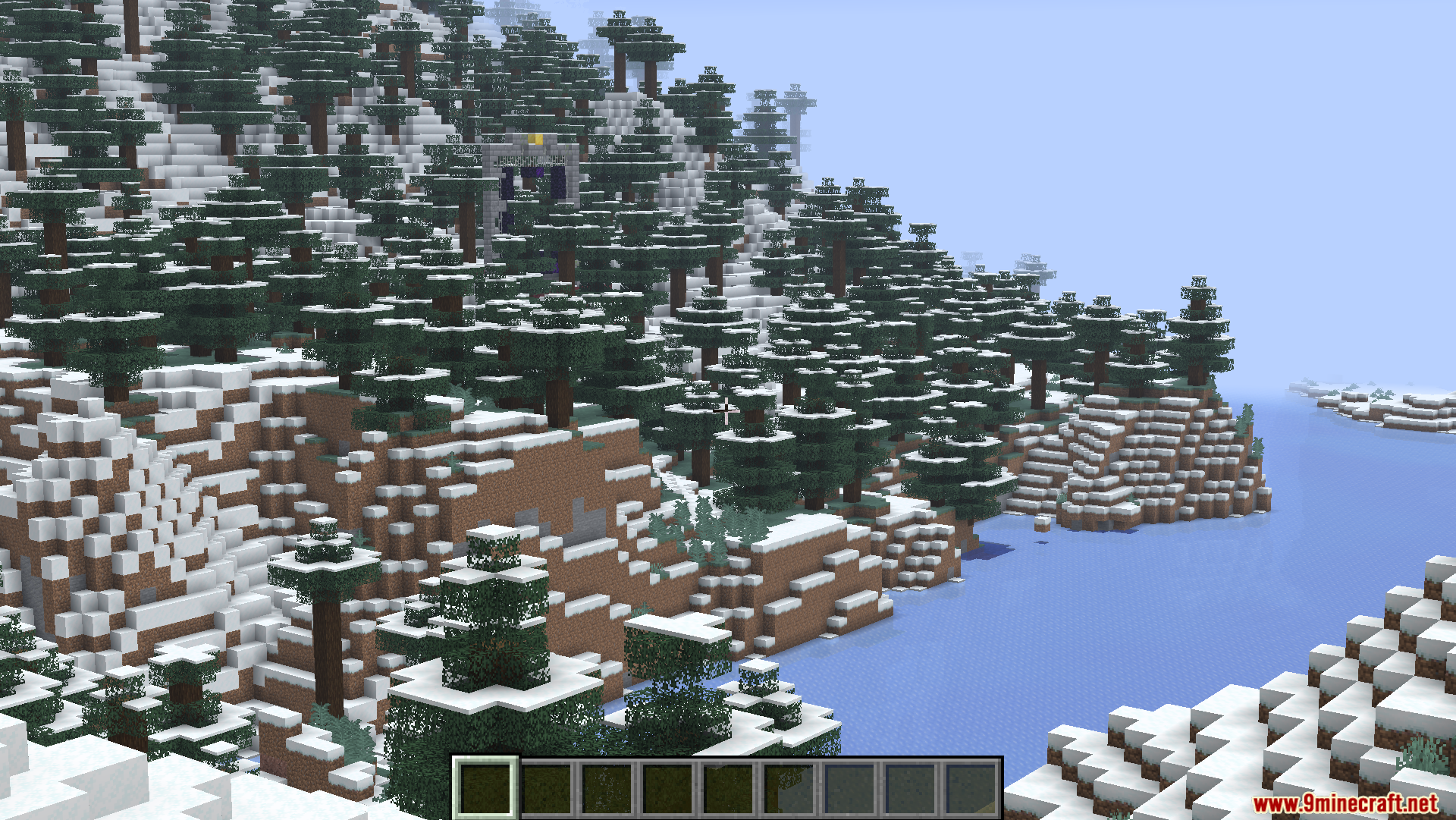 Snowy mountain landscape with spruce trees and a distant nether portal