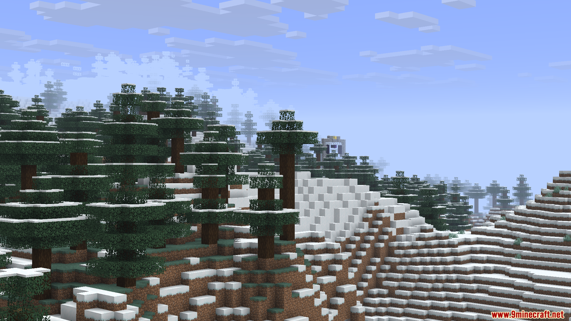 Zoomed view of a snowy forest landscape with a distant structure