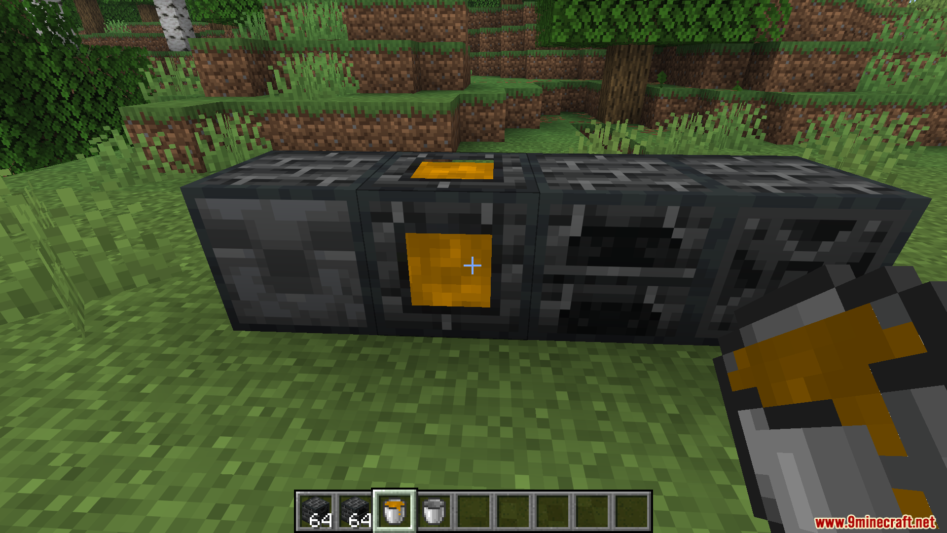 Player holding a bucket of molten metal near custom smelting machines
